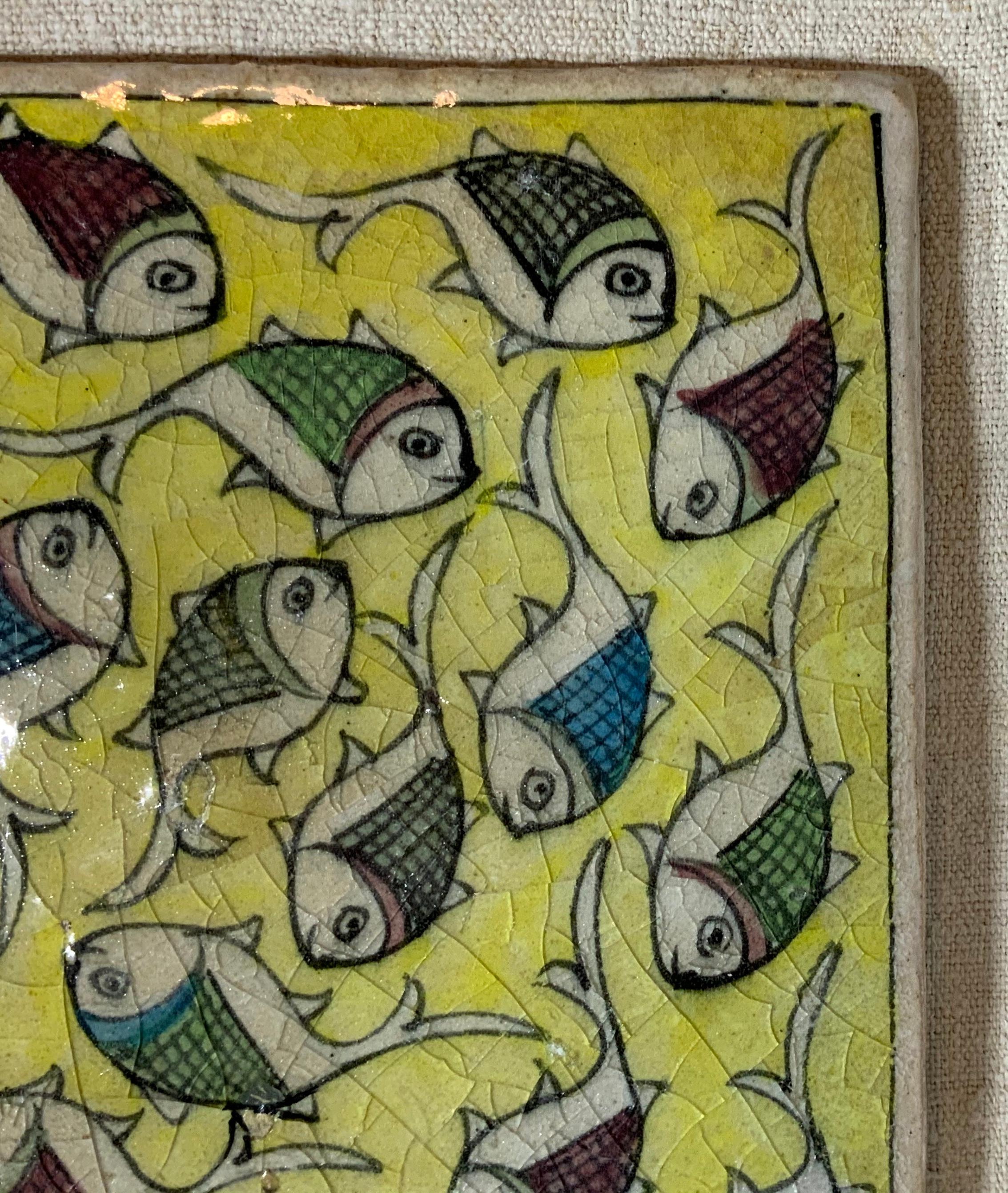 Beautiful Persian tile hand painted and glazed with exceptional wondering school of colorful fish, on yellow color background.
The tile can hang on the wall, or display on wood stand, wood stand is not included.