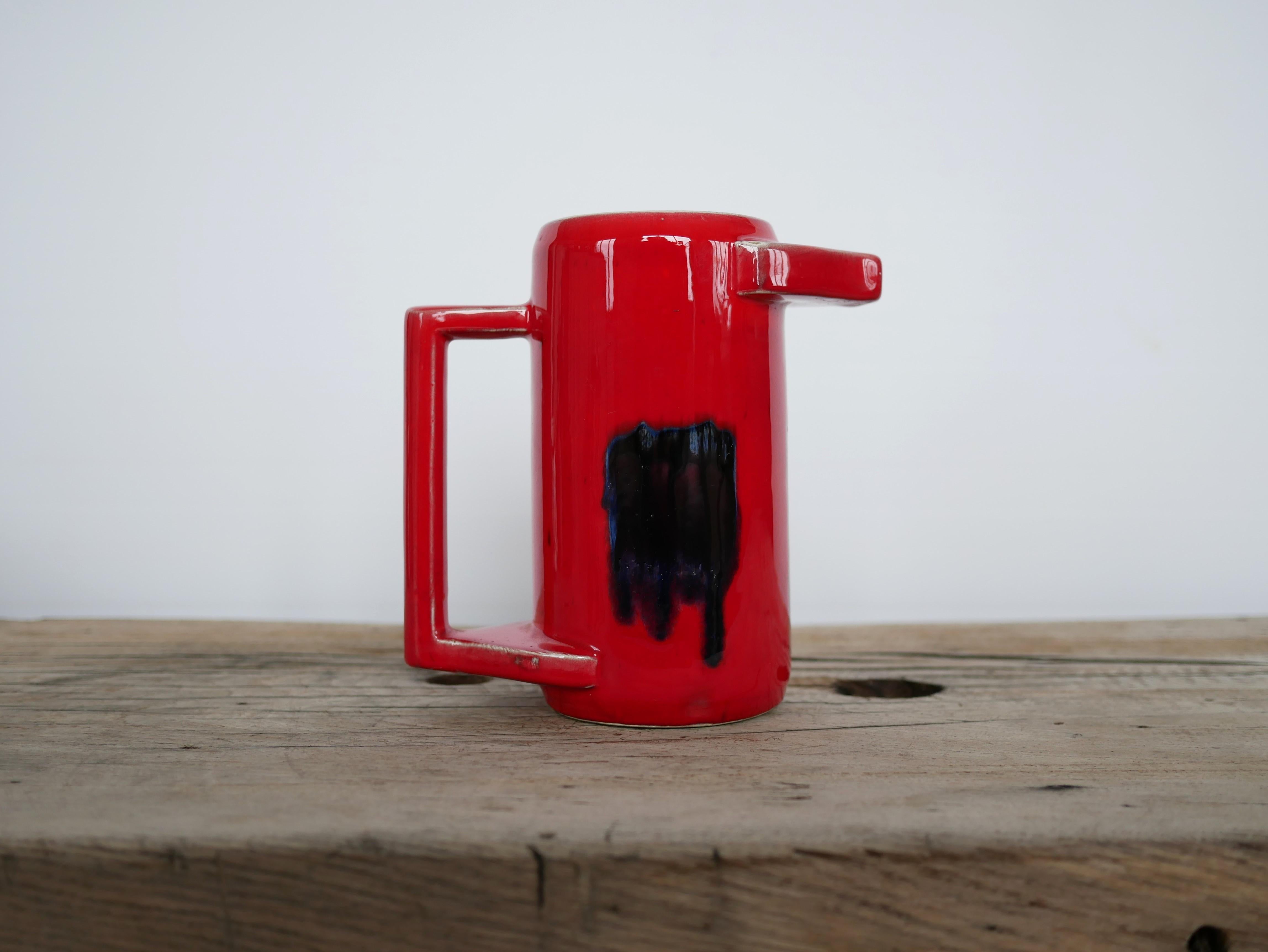 Ceramic pitcher dating from the 60s.

Trendy and current, this pitcher does not lack character, originality and elegance.
It will be perfect in a current decoration, as a decoration on a piece of furniture or on a shelf, used as a pitcher but also