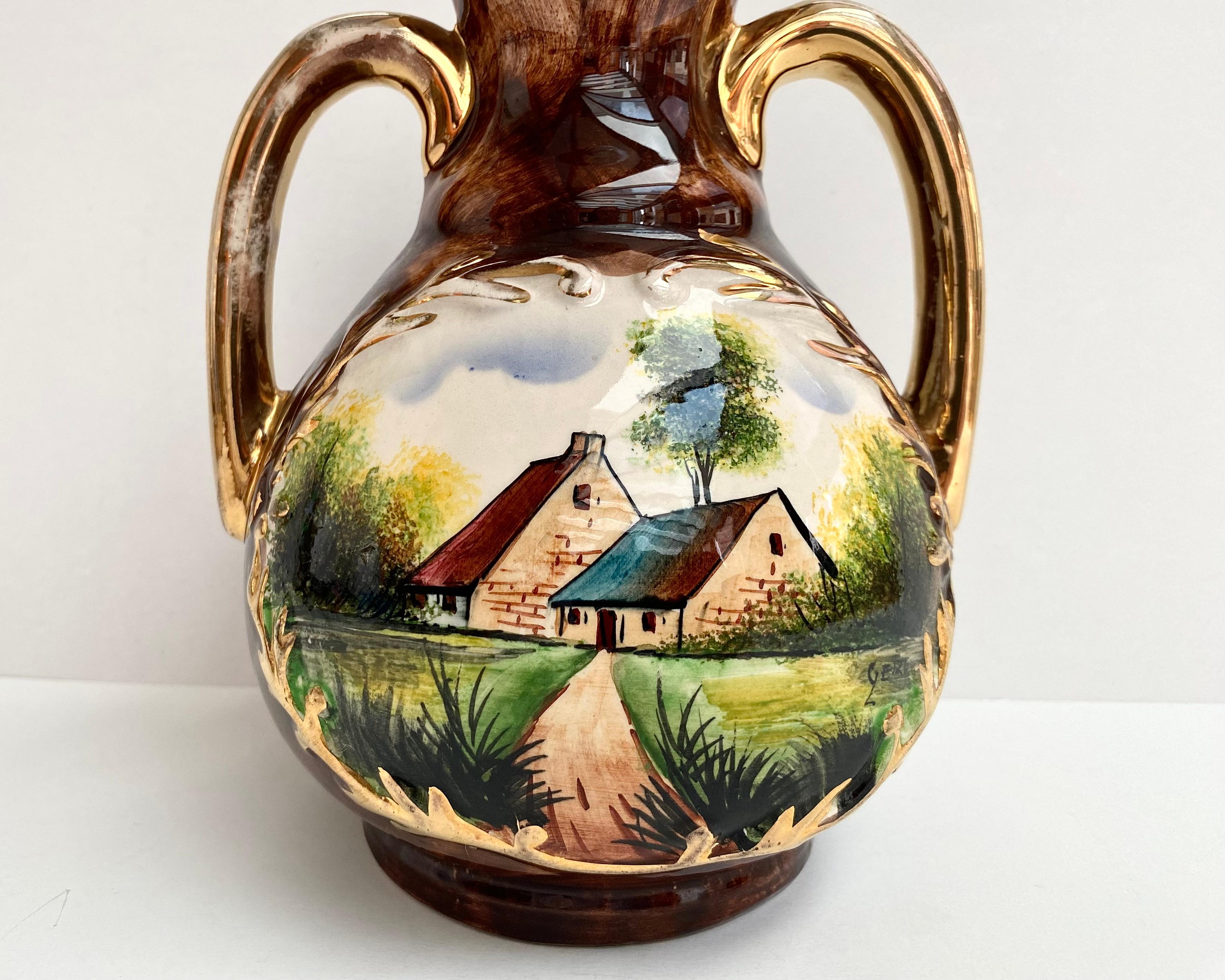 Gorgeous ceramic pitcher / vase with two handles decorated with a beautifull landscape motif and a bright colorful raised enamel and gilding.

Belgium, 1950s.

All hand crafted and hand painted. Stamped and Signed by the artist.

Suitable for