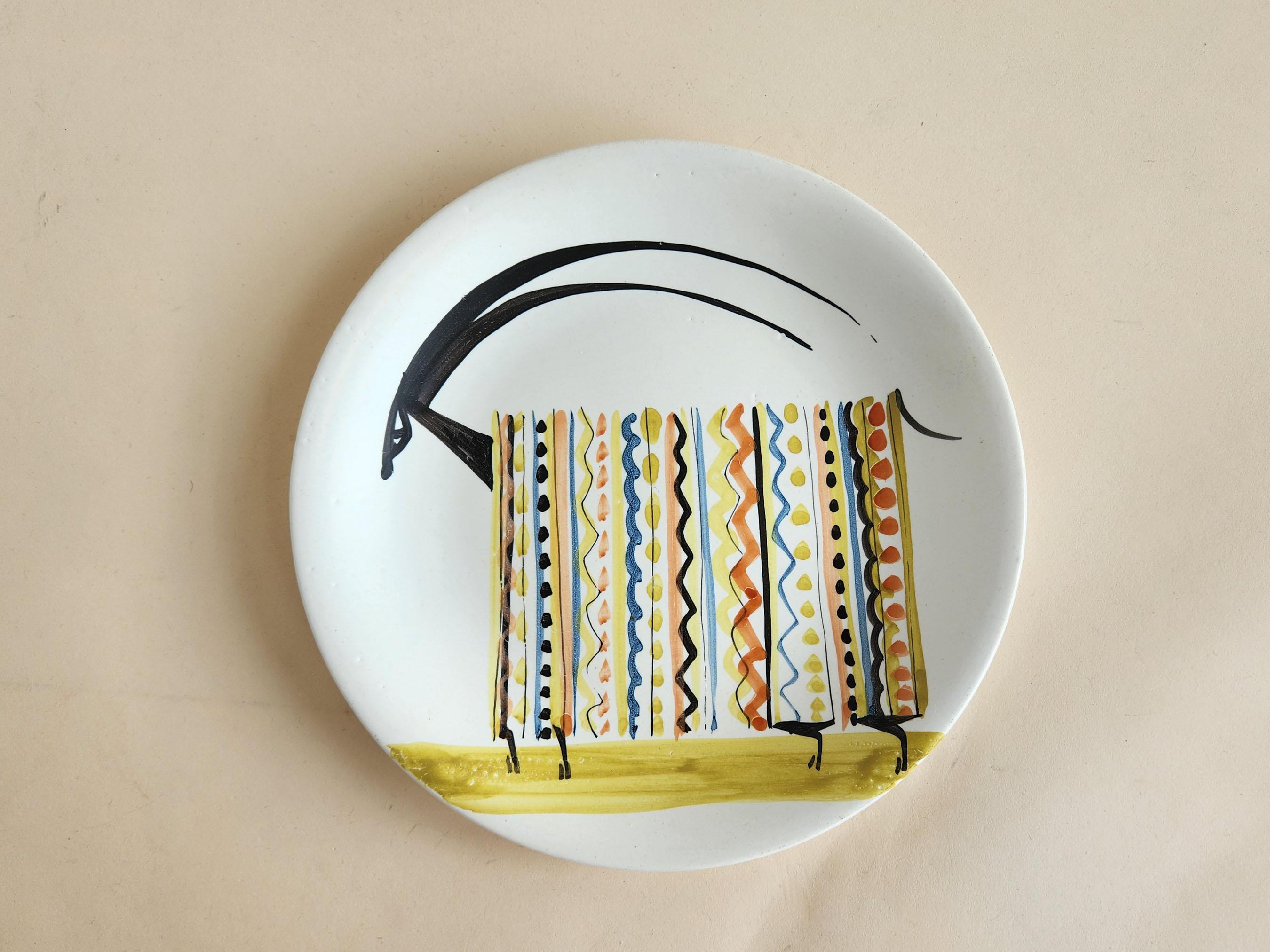 Vintage Ceramic Plate with Ram by Roger Capron - Vallauris, France

Roger Capron was in influential French ceramicist, known for his tiled tables and his use of recurring motifs such as stylized branches and geometrical suns.   He was born in