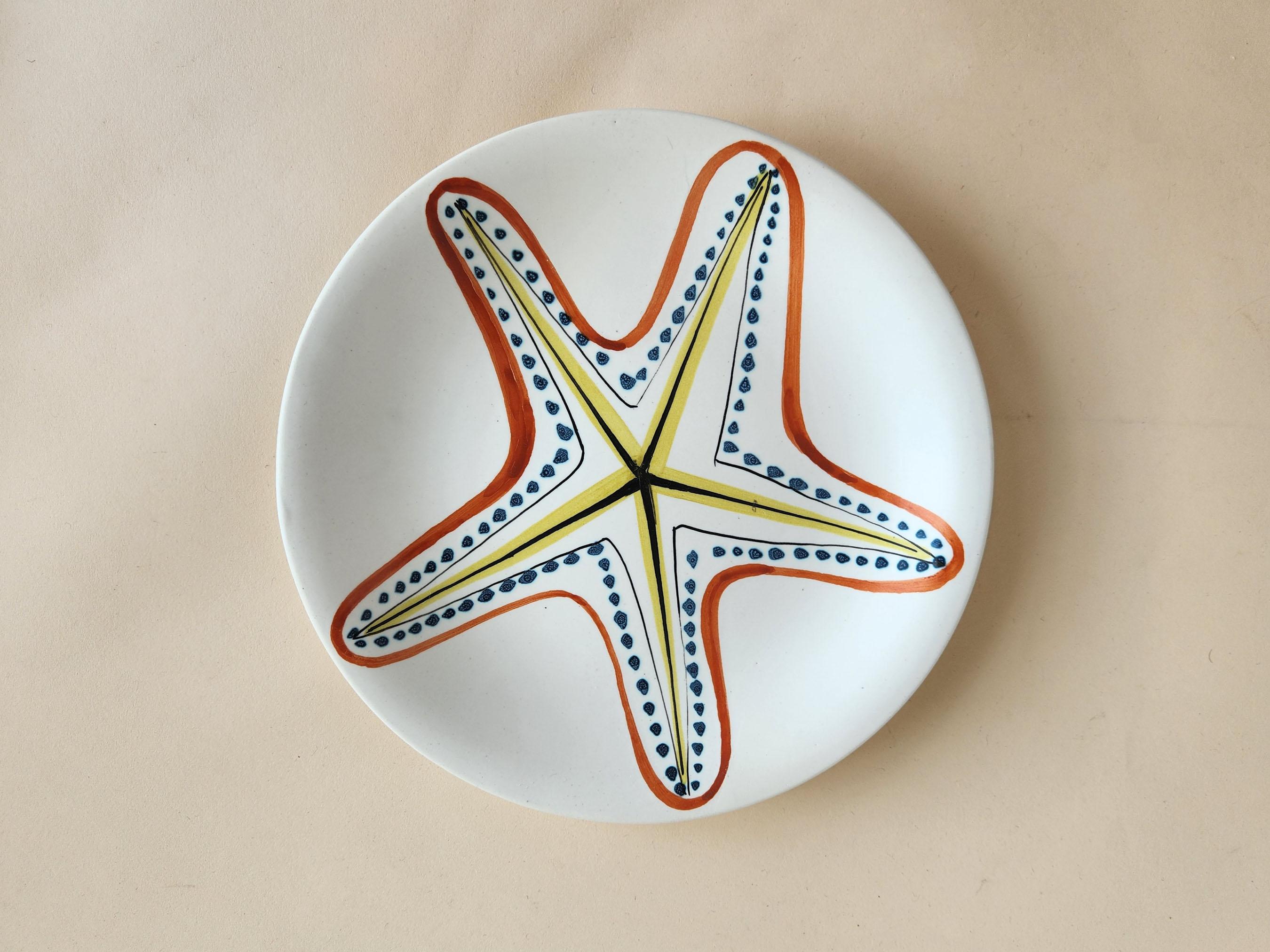 Vintage Ceramic Plate with Sea Star by Roger Capron - Vallauris, France

Roger Capron was in influential French ceramicist, known for his tiled tables and his use of recurring motifs such as stylized branches and geometrical suns.   He was born in