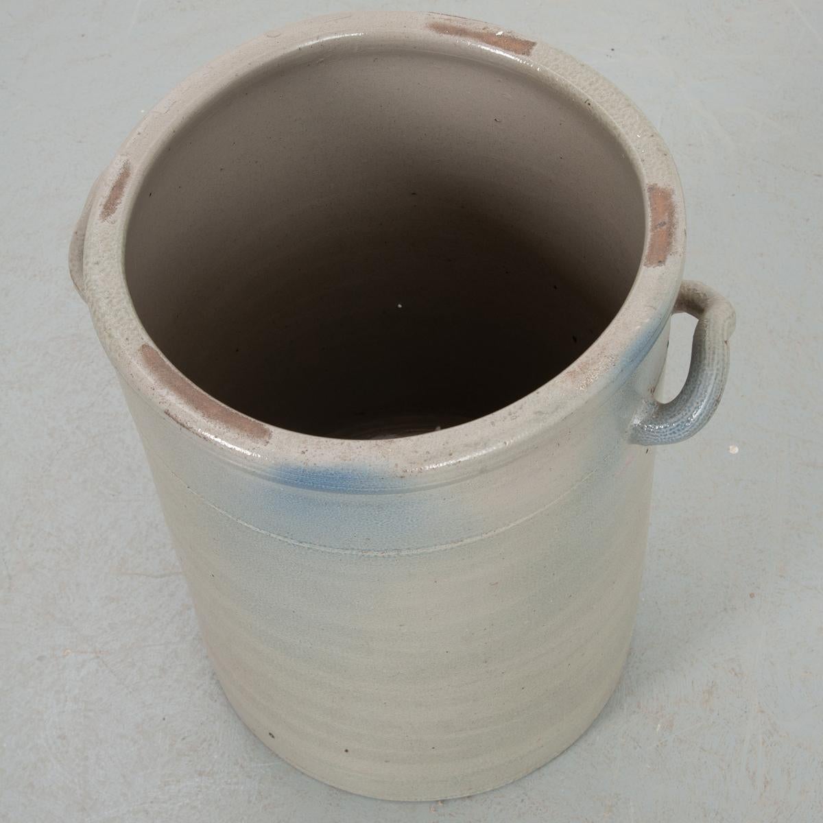 This is a charming ceramic storage jar, painted a light gray color. Its medium size makes it a versatile piece that will easily incorporate into your existing decor. Fixed with two upturned handles for carrying. The interior measures 12-¼”. Make