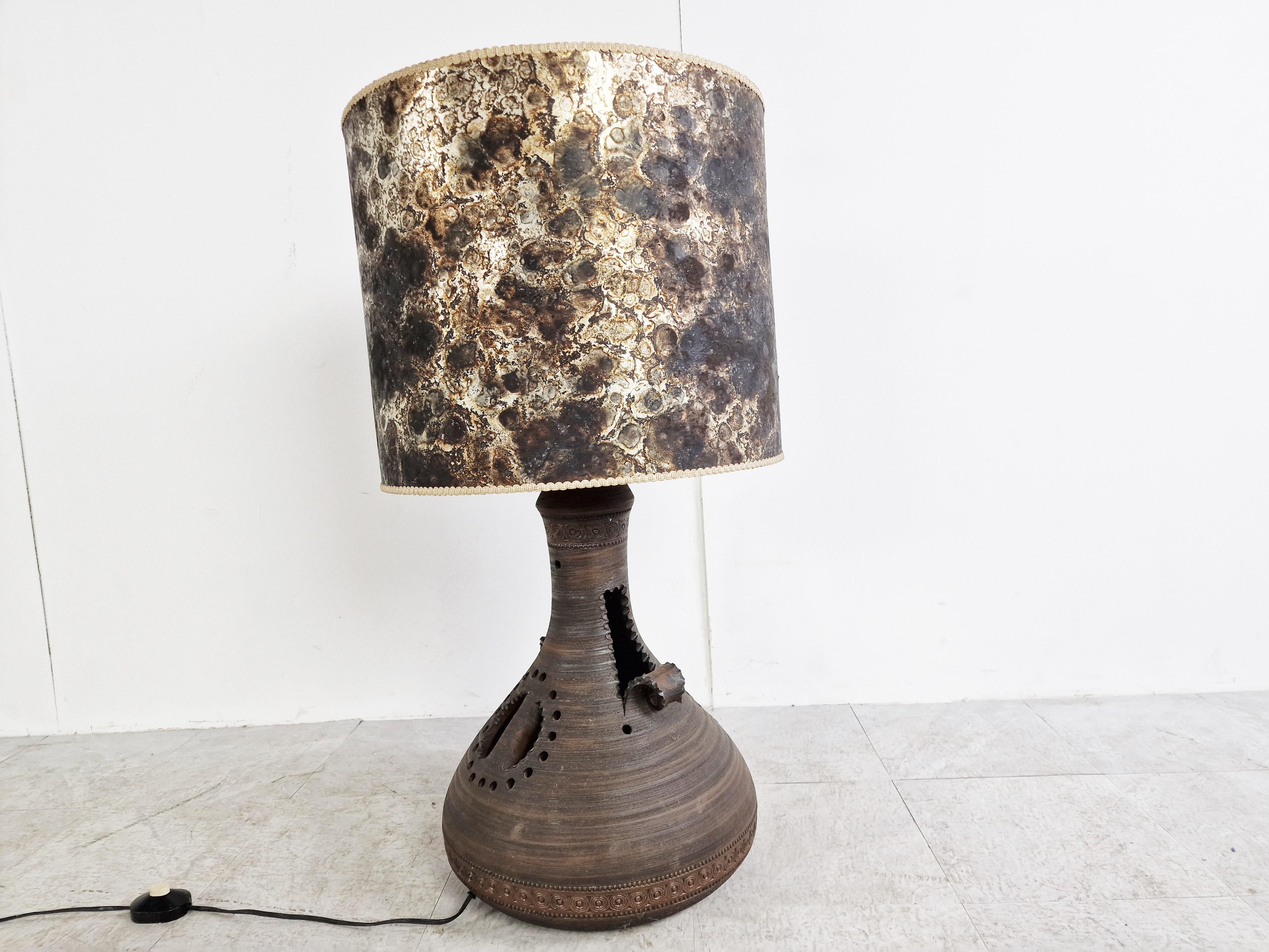 Striking sculptural mid century ceramic table lamp.

Beautiful vintage lamp shade.

Tested and ready to use with a regular E27 light bulb holder.

1960s - Belgium

Dimensions:
Height 91cm/35.82