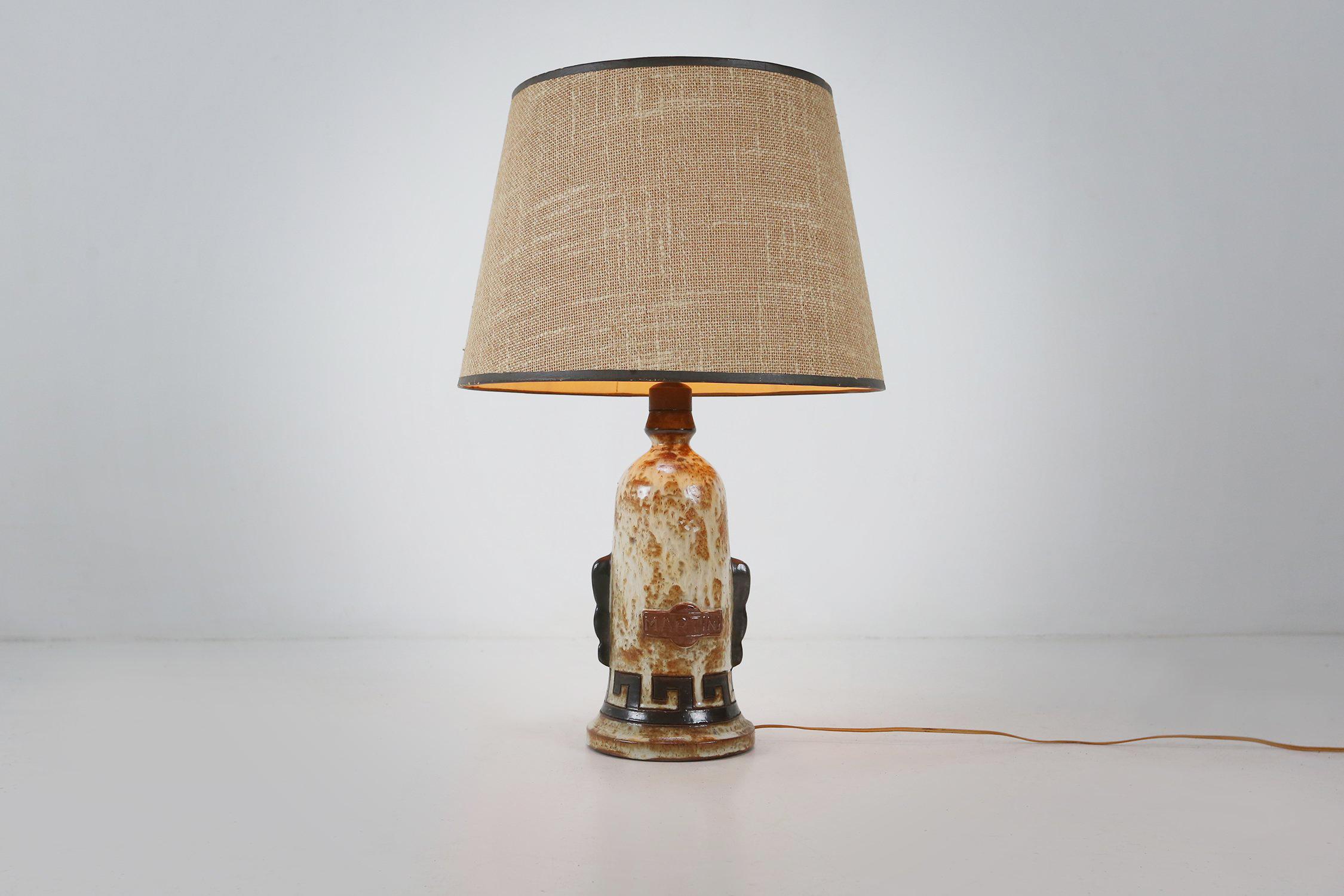 Italy / 1950 / table Lamp / Martini / ceramic / Vintage / Mid-century

Mid-century glazed ceramic table lamp by the Italian Vermouth brand Martini from the 1950. Decorated with carved and glazed geometric patterns and the martini logo and a large