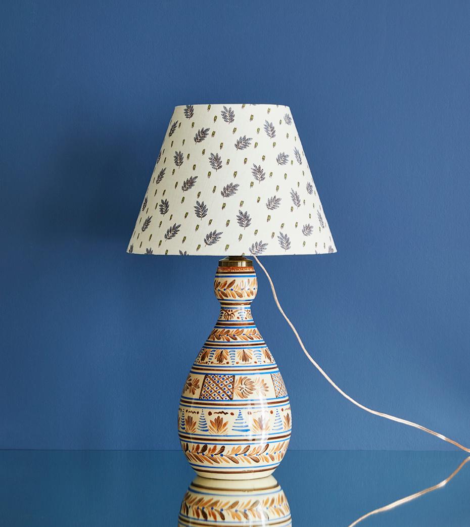 Beautiful ceramic table lamp in crème glaze with a detailed brown and blue pattern. New upholstered lamp shade.