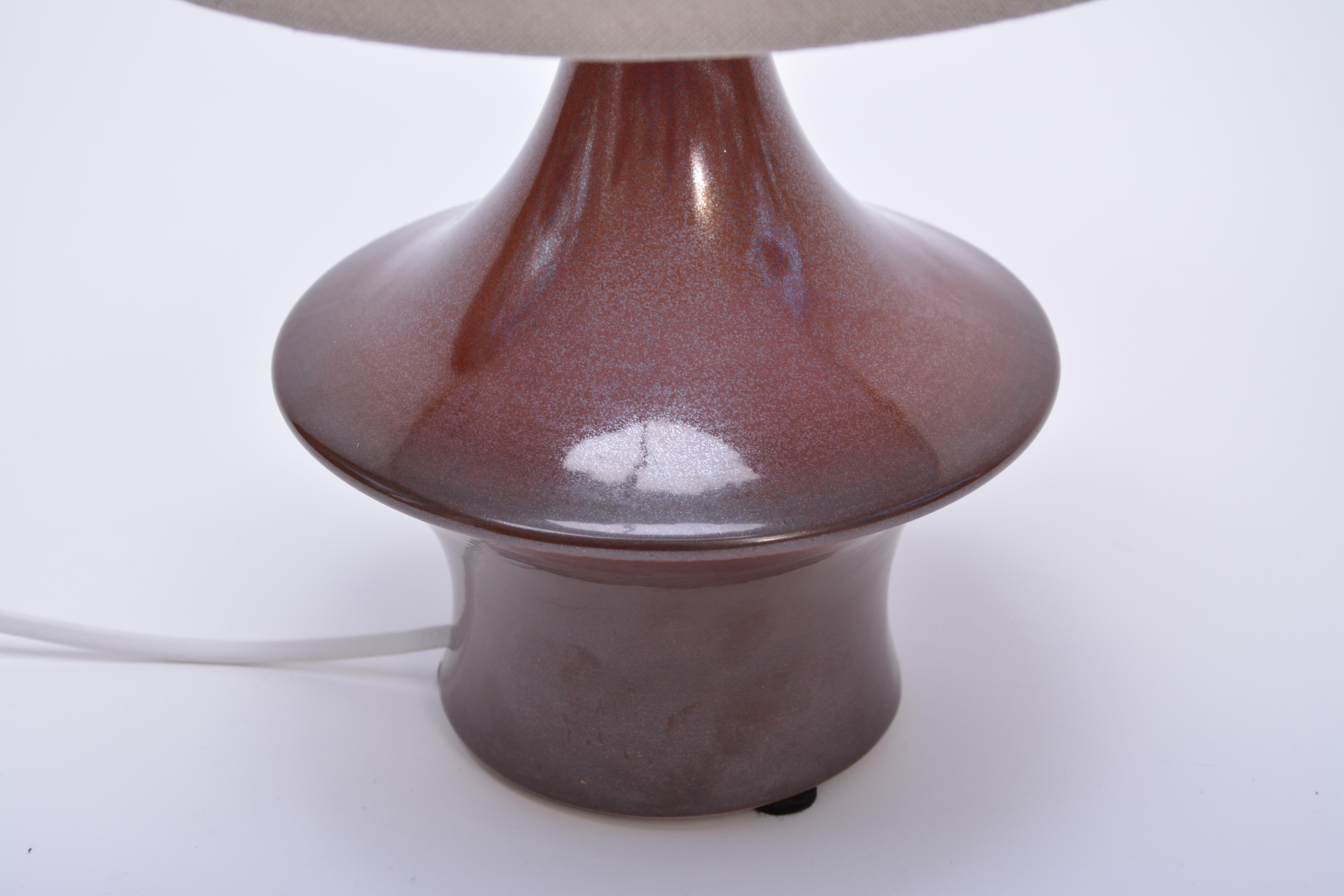 Danish Mid-Century Modern table lamp by Søholm Stentoj

This lamp was produced in Denmark by Søholm Stentoj. It is made of stoneware and features a ceramic glaze in tones of red and brown.
Søholm or Søholm Stentøj (Soholm Stoneware) dates back to