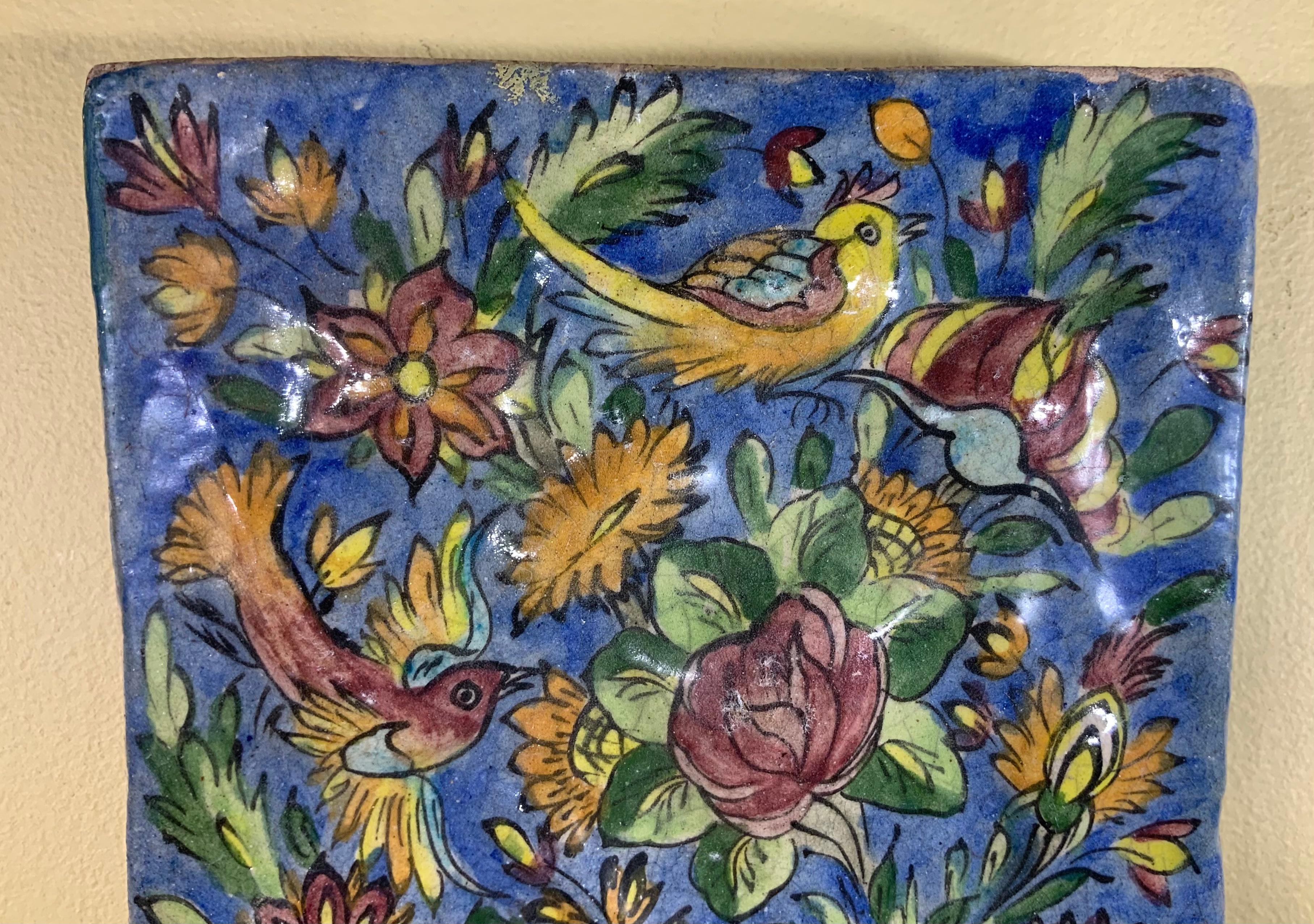 Exceptional tile all hand-painted and glazed with beautiful scenery of birds flying between colorful vines and flowers on a blue color background. Could hang on the wall.
Great object of art for wall display.

 