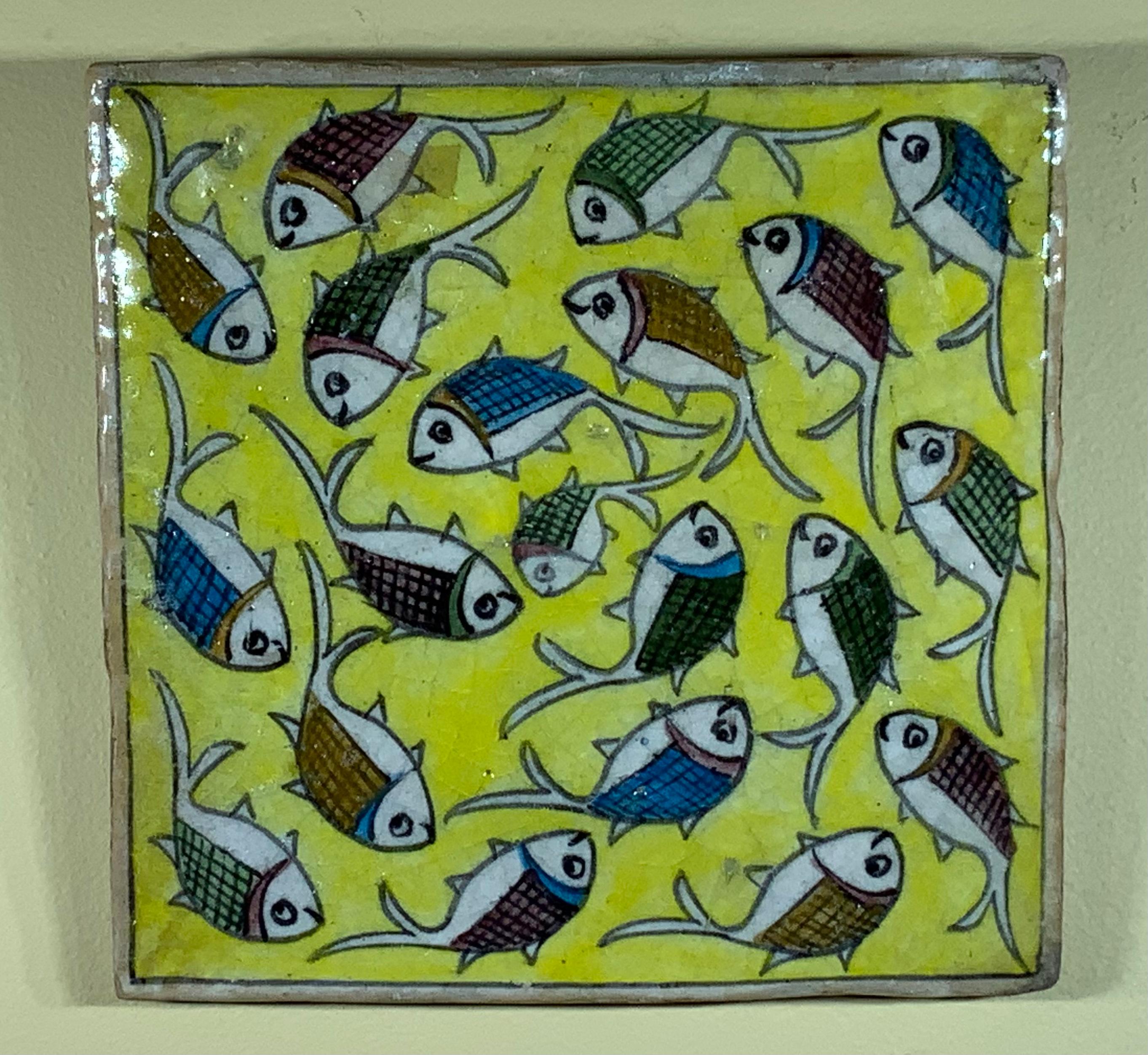 Beautiful tile hand painted and glazed tile with exceptional wondering colorful school of fish on a yellow color background. The tile can hang on the wall. Exceptional object of art for wall display.