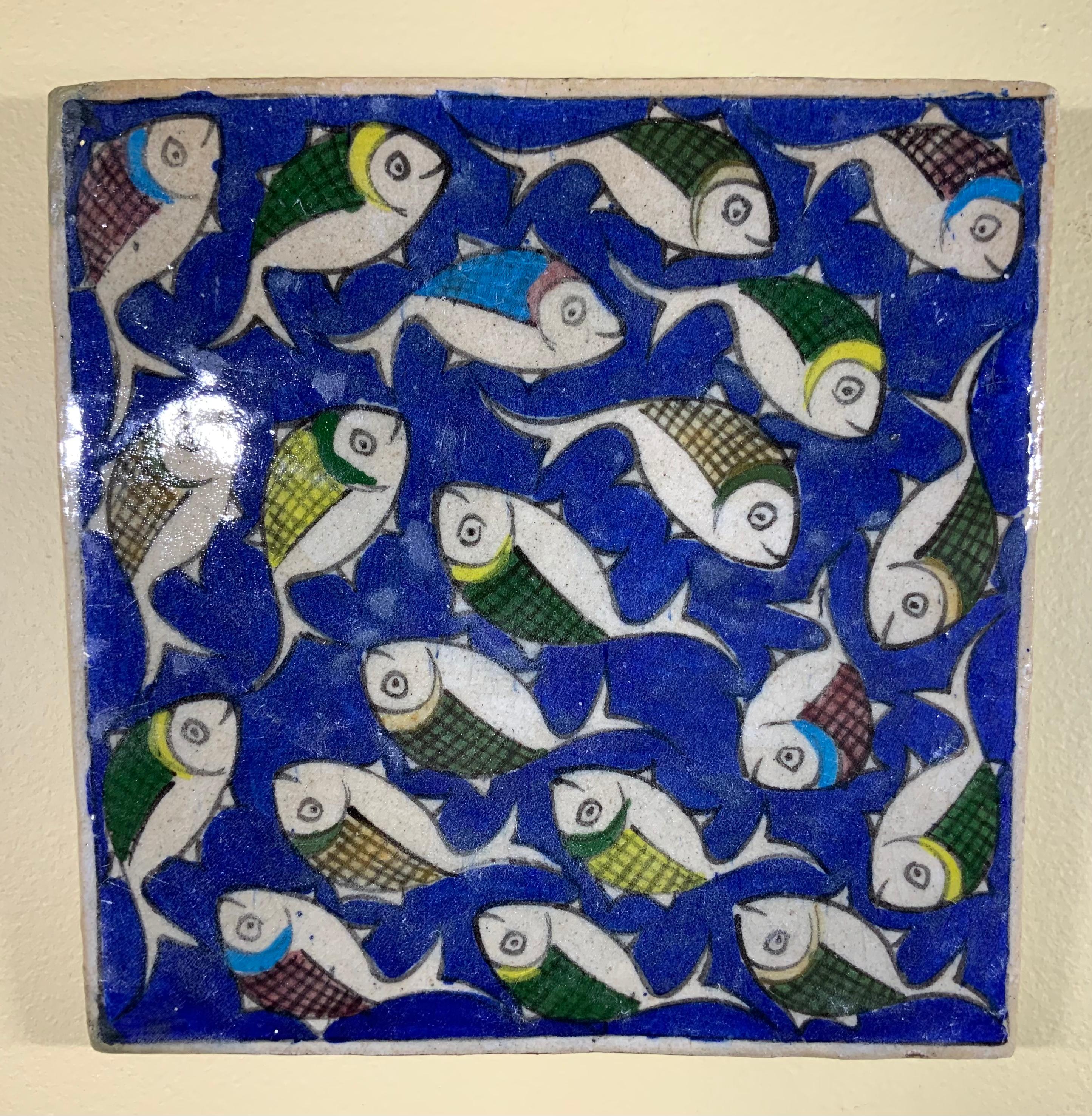 Beautiful tile hand painted and glazed with exceptional wondering colorful school of fish on a blue color background. The tile can hang on the wall. Exceptional object of art for wall display.