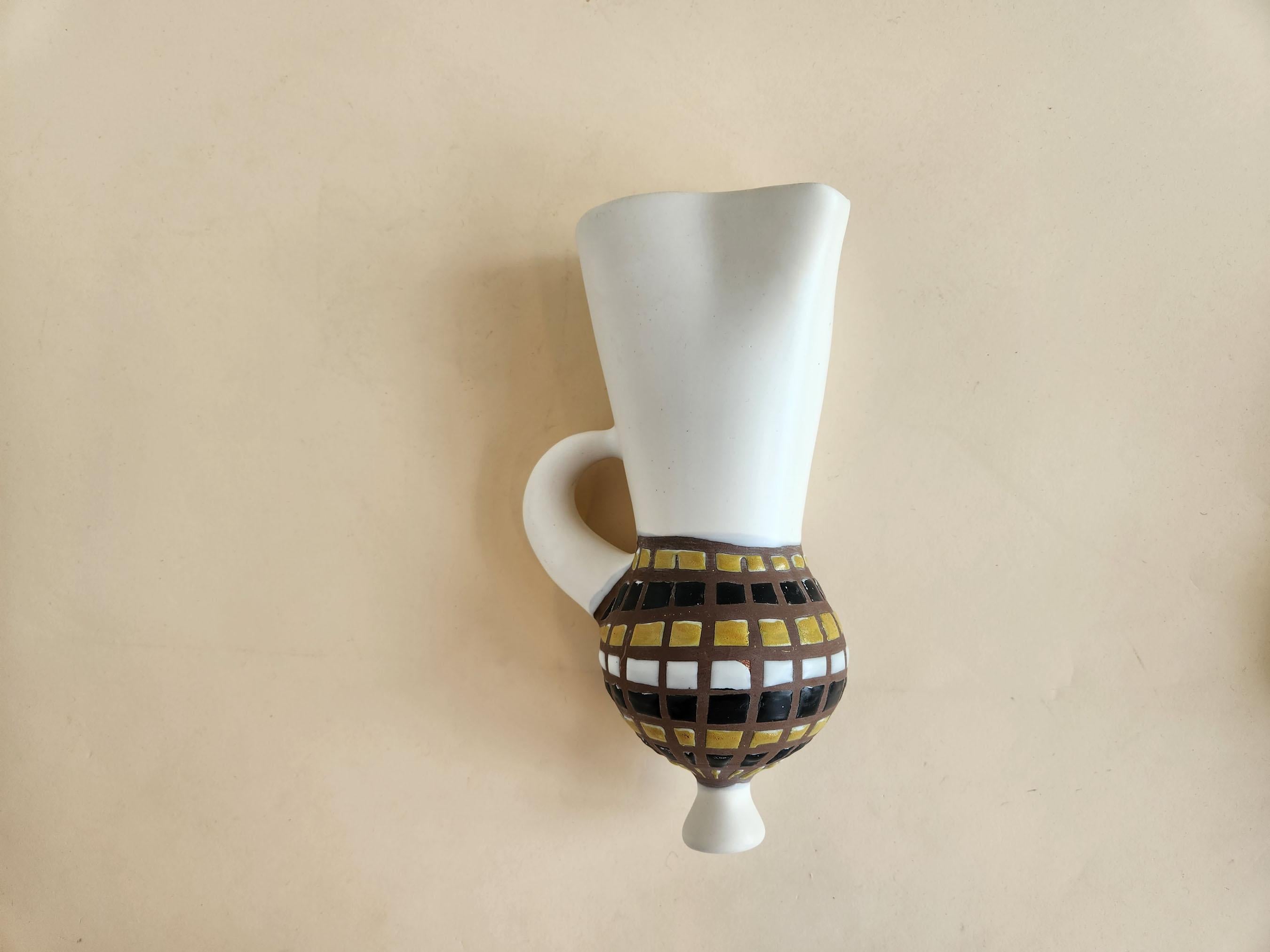 Vintage Ceramic Wall Mounted Vase with Cobblestones by Roger Capron - Vallauris, France

Roger Capron was in influential French ceramicist, known for his tiled tables and his use of recurring motifs such as stylized branches and geometrical suns.  