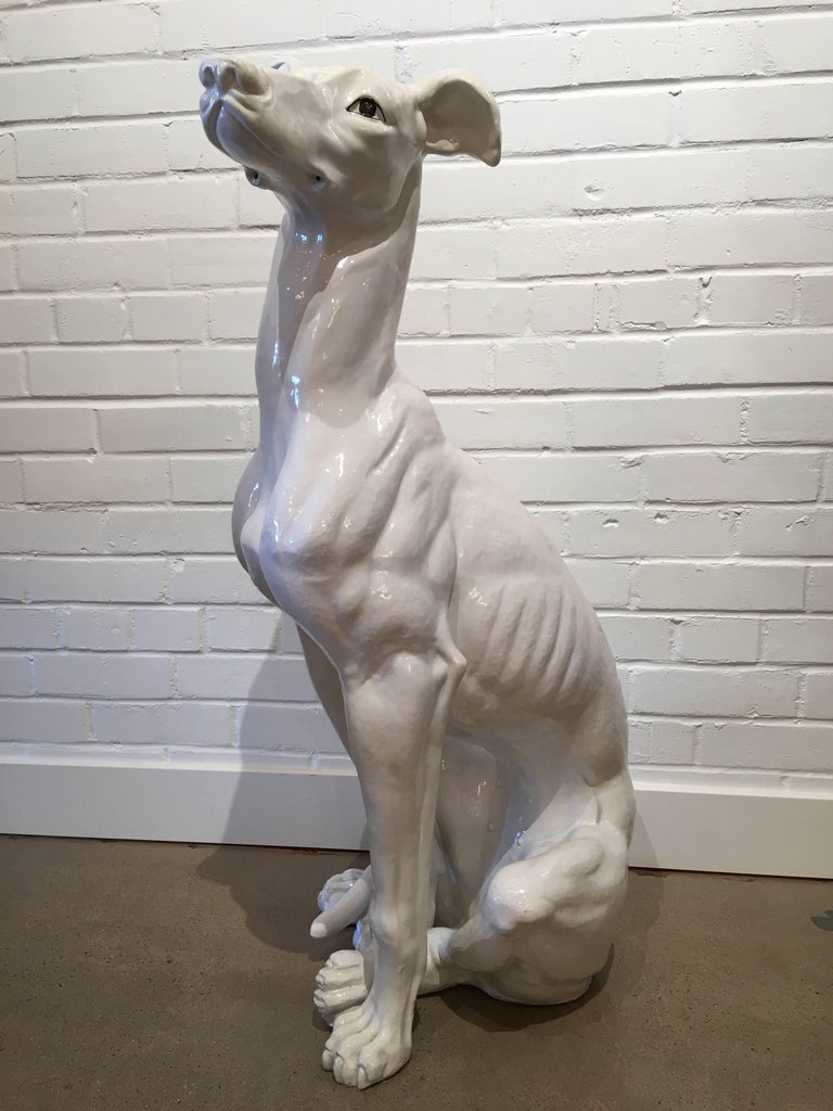white ceramic greyhound statue