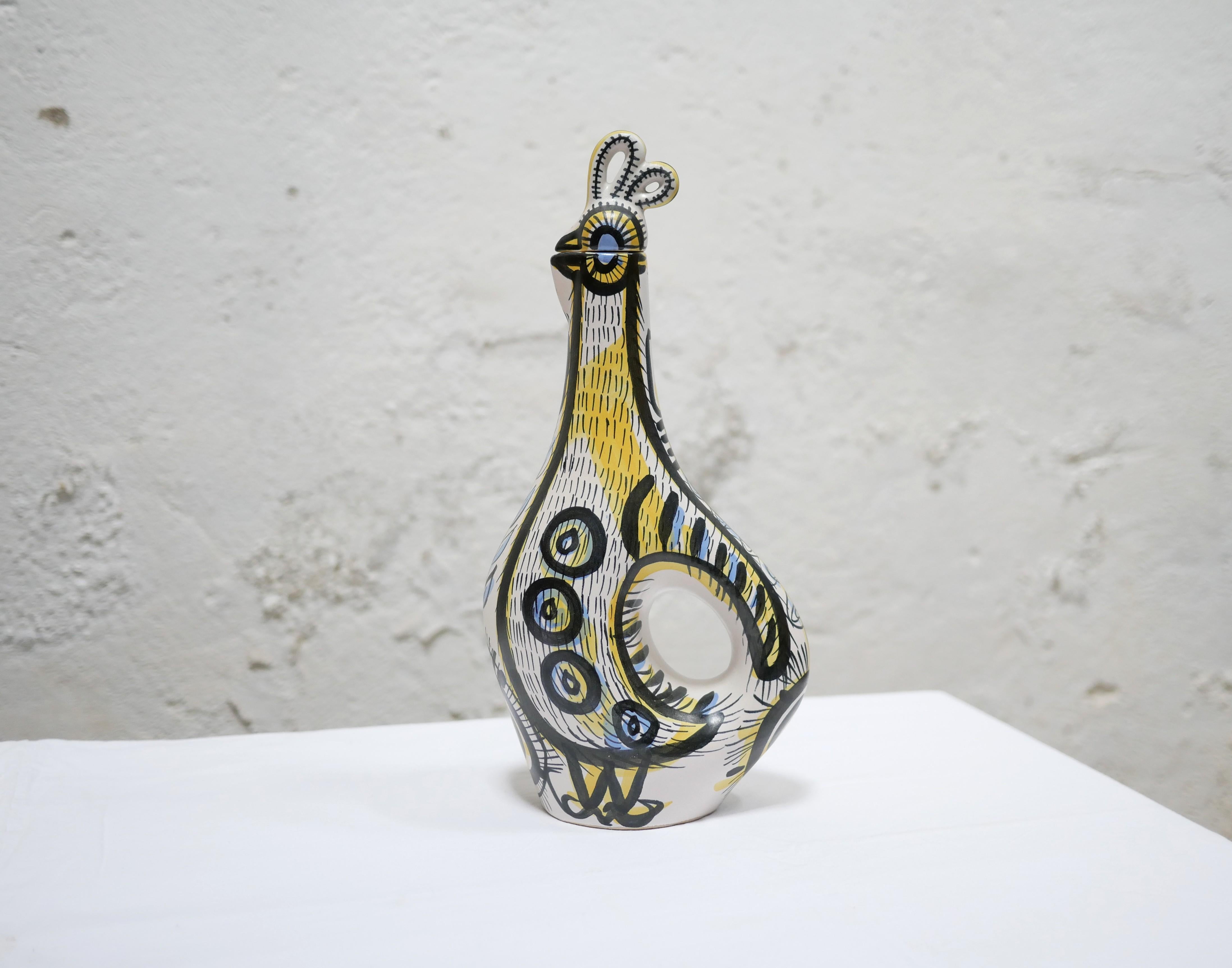 Zoomorphic ceramic rooster pitcher designed by ceramist Pierre Toulhoat and decorated by Jean Delima for the Keraluc factory, Quimper, France, 1960s.

Beautifully crafted, with a modern shape, intense colors, and artistic motifs, this ceramic jug is