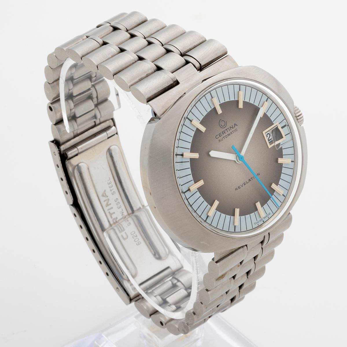 Our vintage Certina Revelation features a flying saucer 36 x 42mm stainless case with degrade grey dial and unusually, its original stainless steel bracelet and turquoise seconds hand. Wonderful and retro, this example of reference 5801 is presented