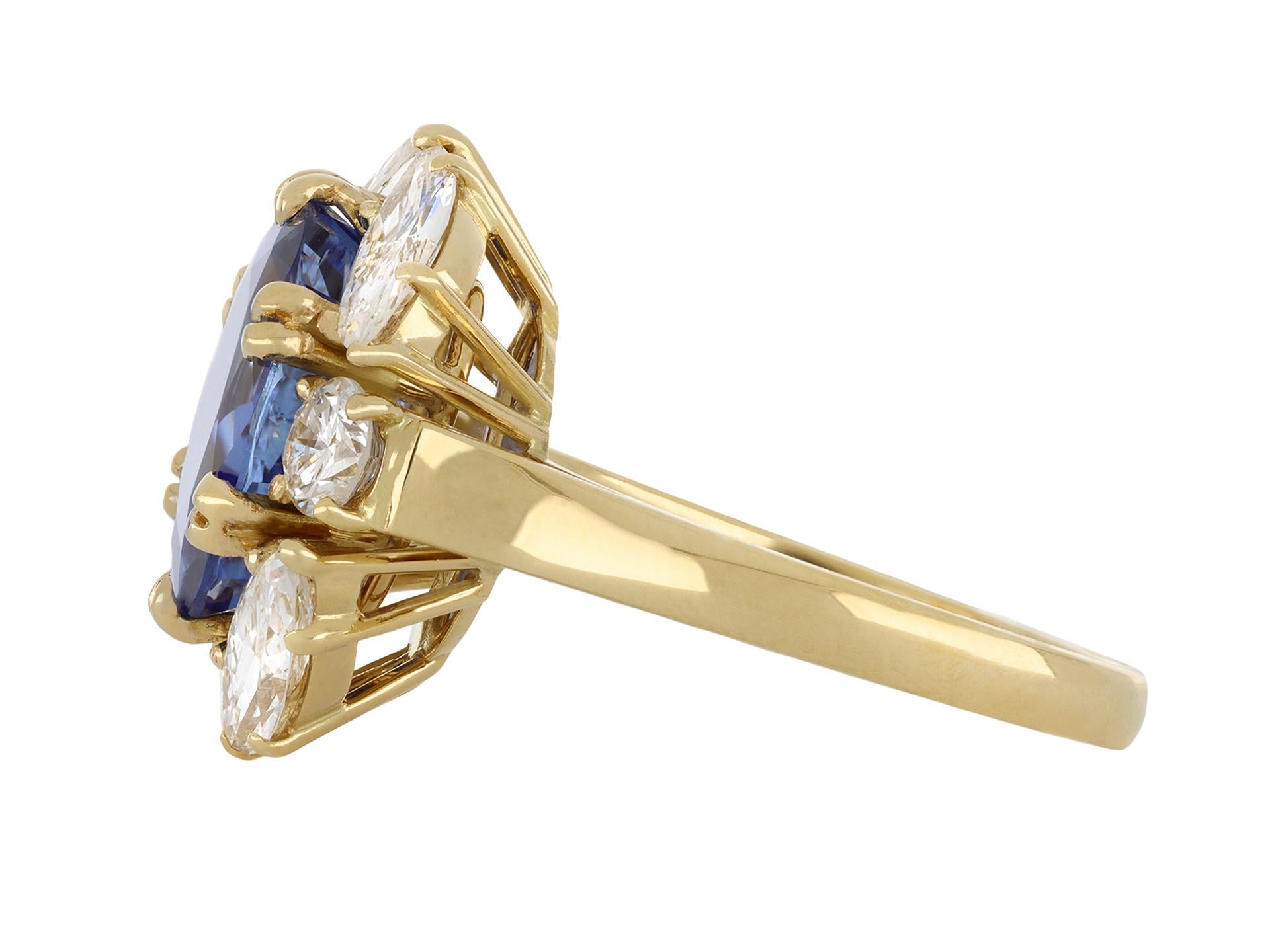 Vintage Ceylon sapphire and diamond cluster ring. Centrally set with one oval old cut natural unenhanced Ceylon sapphire in an open back claw setting with an approximate weight of 5.98 carats, further set with four marquise brilliant cut diamonds in
