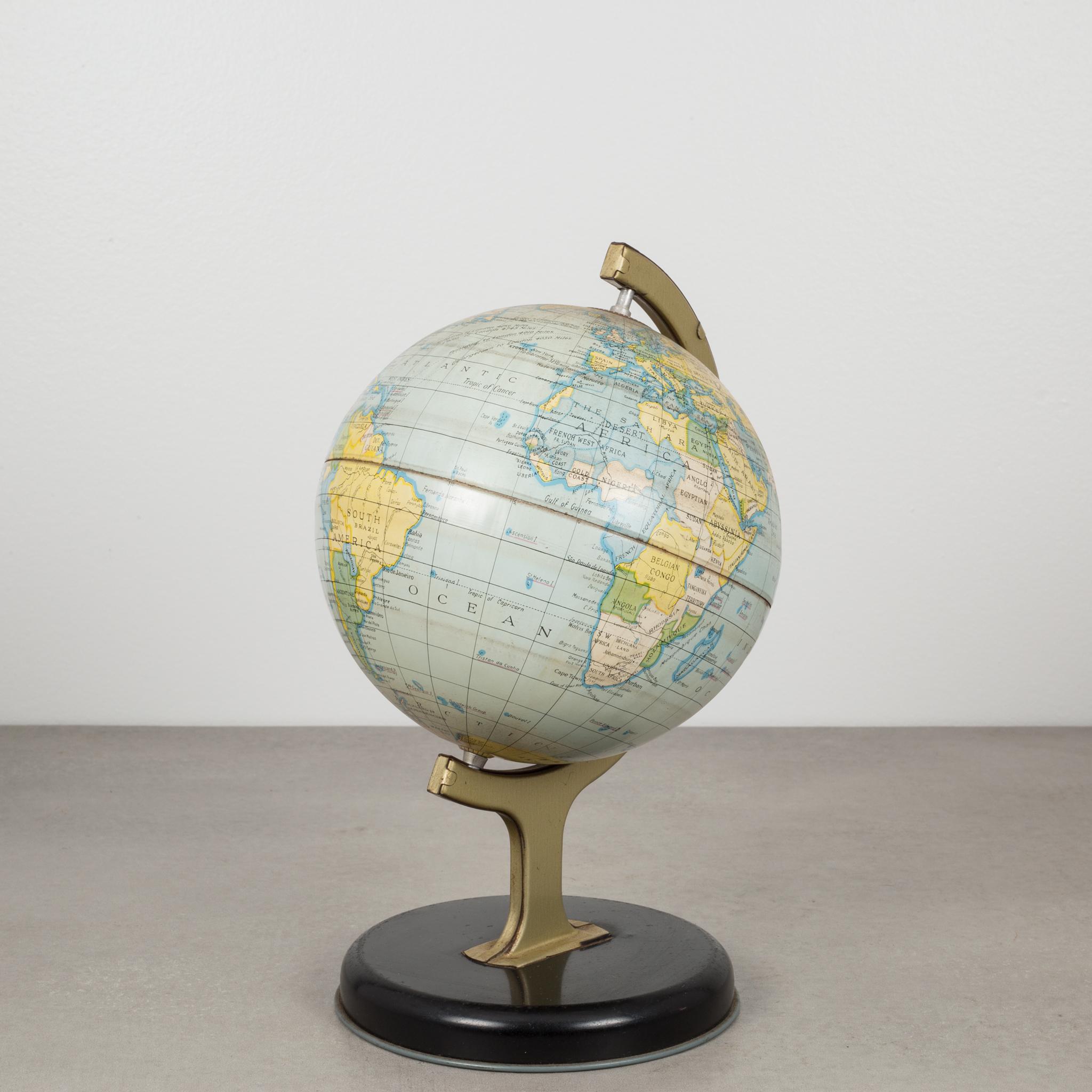 Small tin educational rotating globe used to teach time around the world.