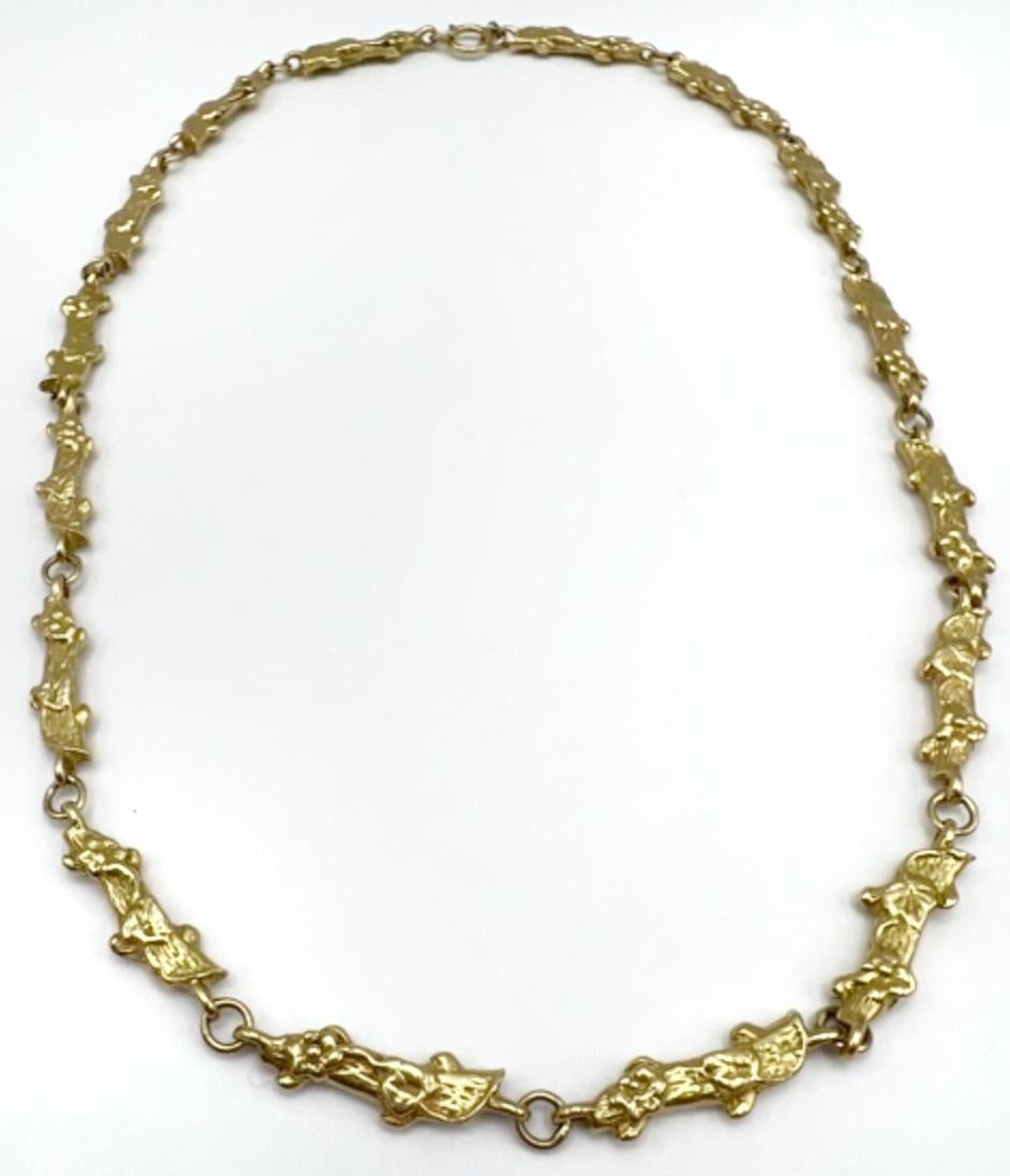 MATERIALS: 14K Yellow Gold
WEIGHT: 58.1 grams
MEASUREMENTS: Length: 19 inches, Width: 3/16 inches
HALLMARKS: 14K
ITEM DETAILS:
A beautiful vintage chain necklace made of 14k gold nuggets with floral design. Elongated gold nugget elements are