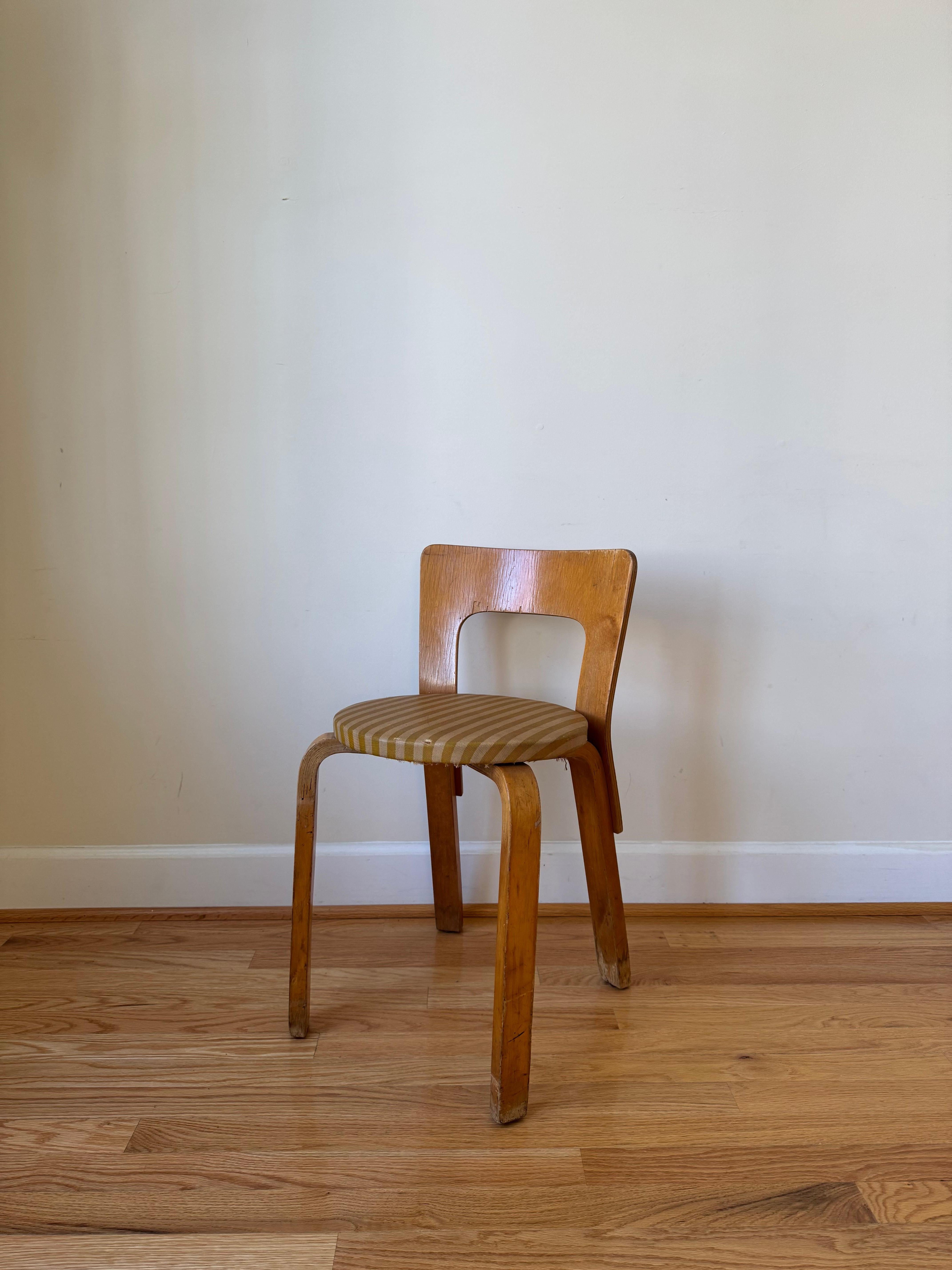 Clean lines and a simple structure define the design of Chair 65. 

A low, rectangular backrest is formed from a single piece of birch plywood and has a slight curve that forms naturally to the back, offering comfort and support. 

The height of the