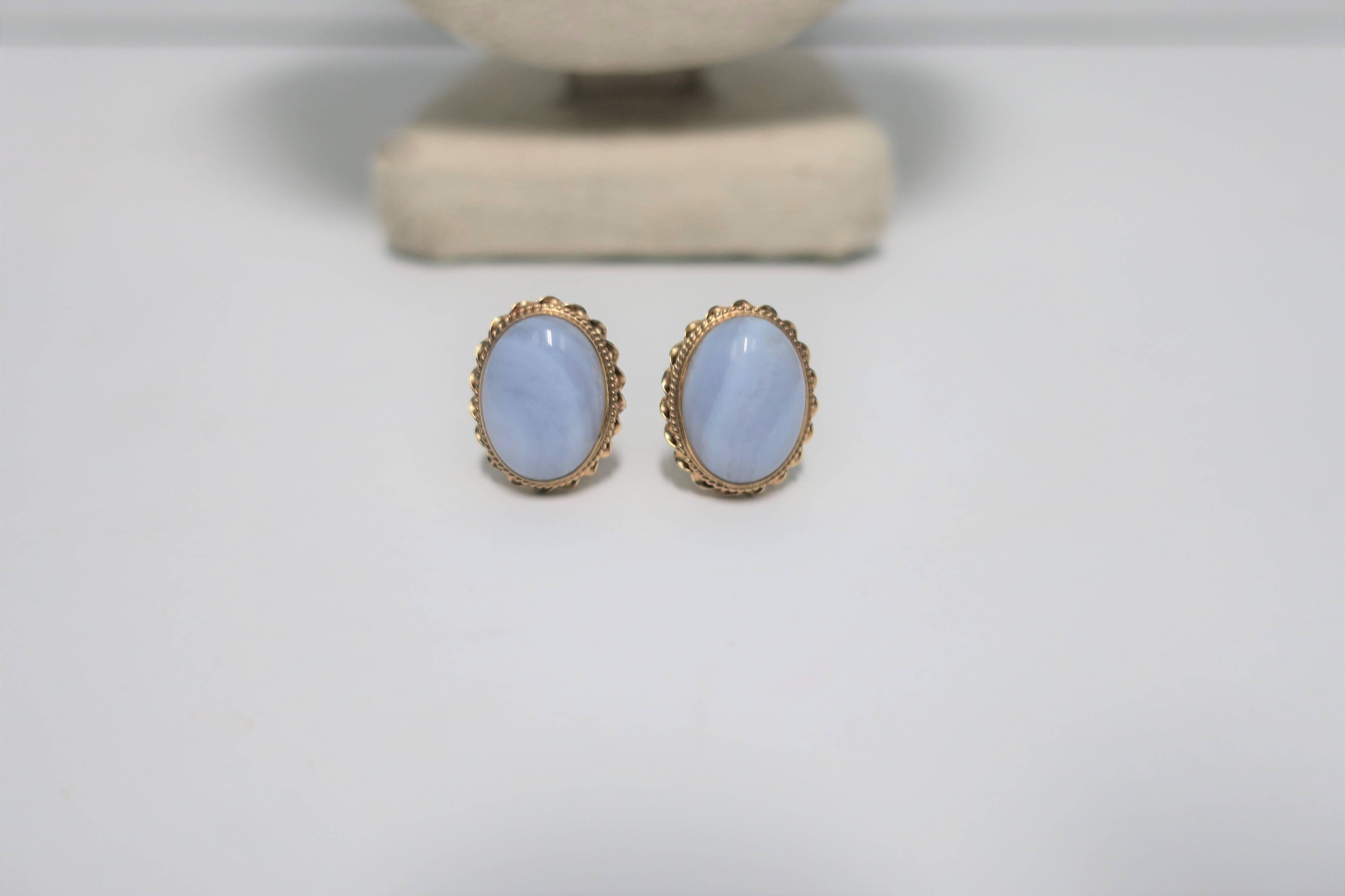 A pair of vintage oval chalcedony quartz and 14-karat yellow gold earrings, circa mid-20th century. Each earring has maker's mark 