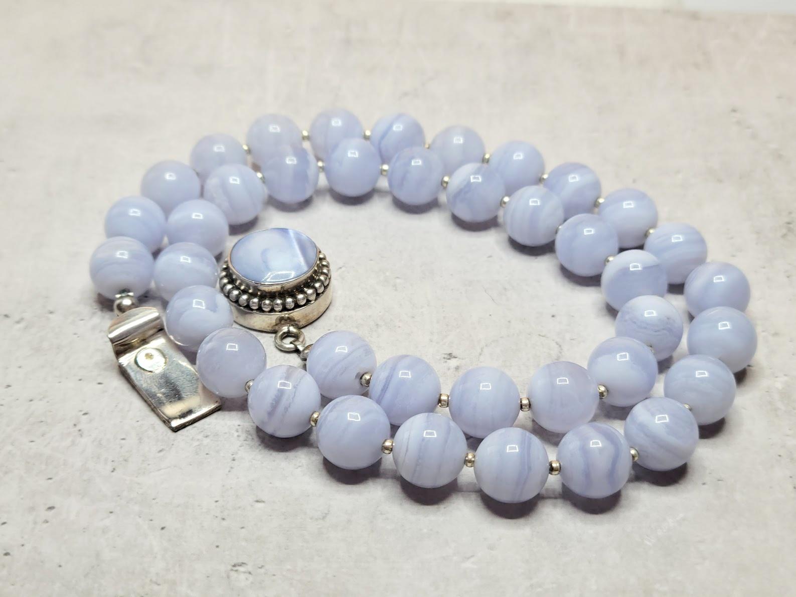 The length of the necklace is 19 inches (48 cm).
The size of the smooth round beads is 10 mm.

Blue Agate and Blue Lace Agate are interchangeable names of the same type of banded Chalcedony belonging to the microcrystalline Quartz family. However,