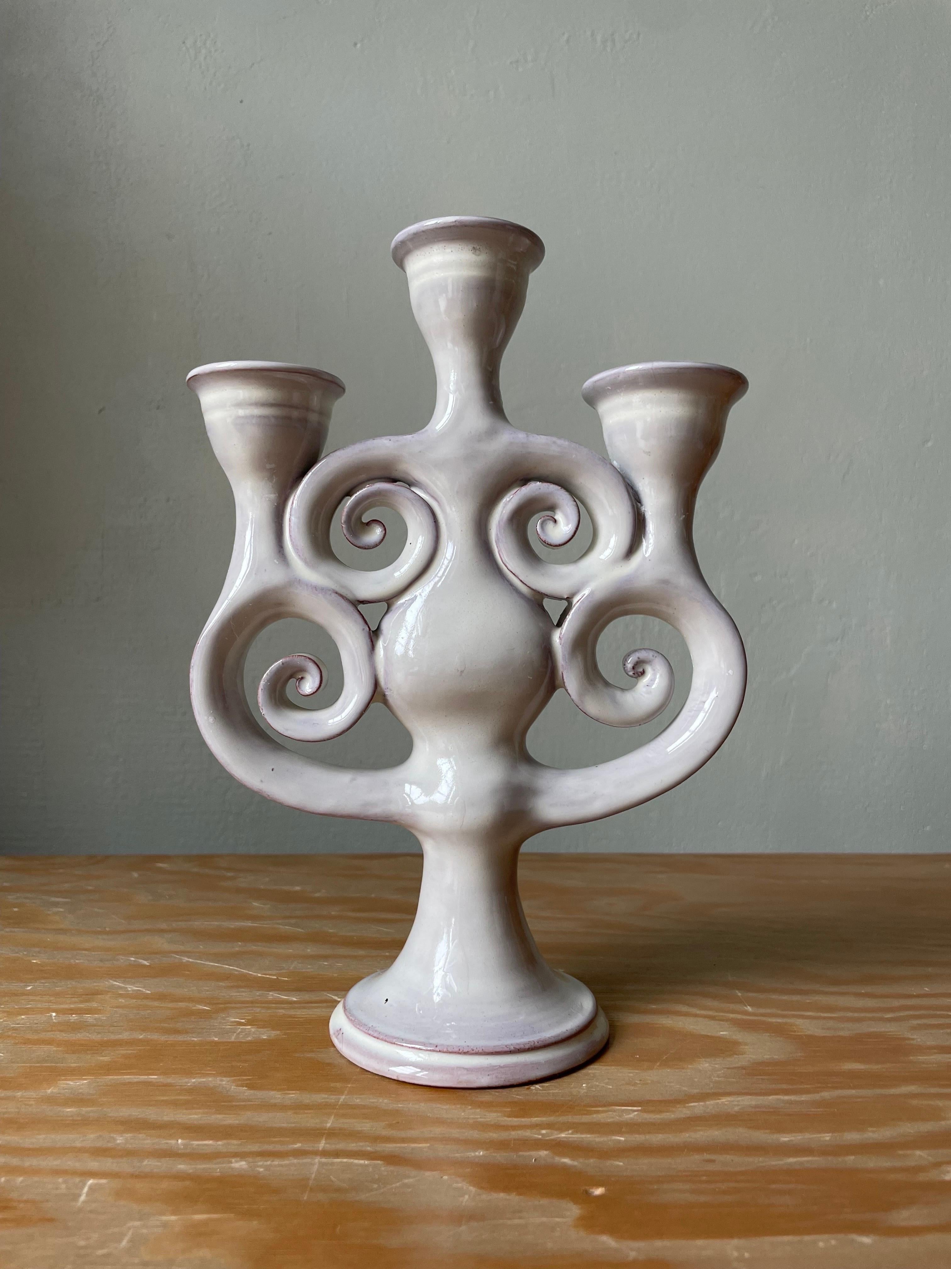 Handmade ceramic three arm candelabra with shiny greyish white glaze. Soft organic modern shapes with swirling decor. Small crackles in glaze. Handmade in Denmark in the 1970s. Beautiful vintage condition. 
Denmark, 1970s.