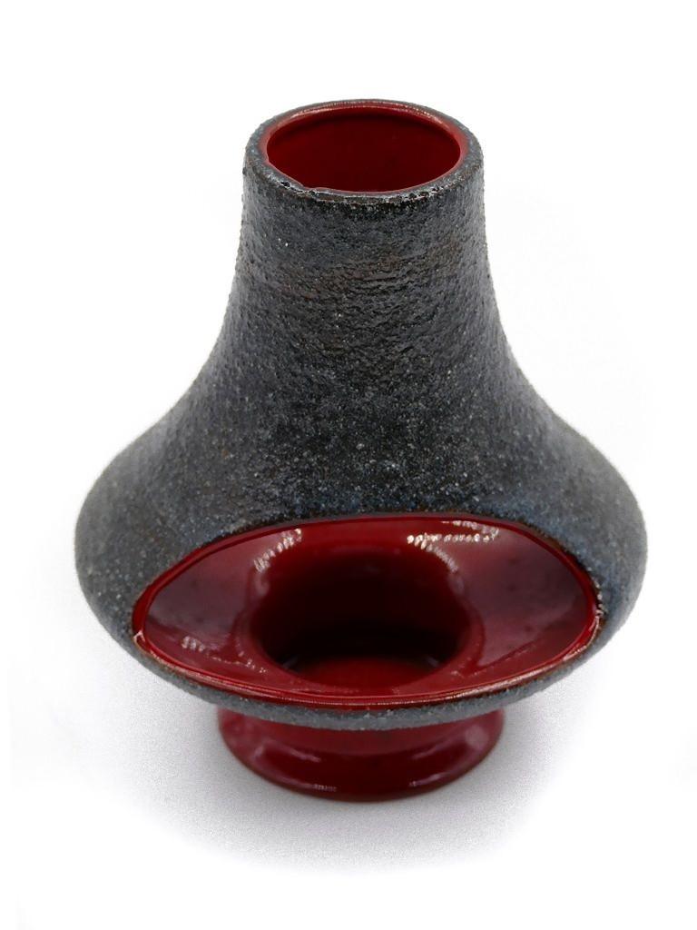 Vintage Chamotte candleholder is a rare decorative object realized in the 1970s by German manufacture. 

Realized entirely chamotte clay, a particular raw material for making ceramics with silica and alumina. Red-colored inside.

Very good