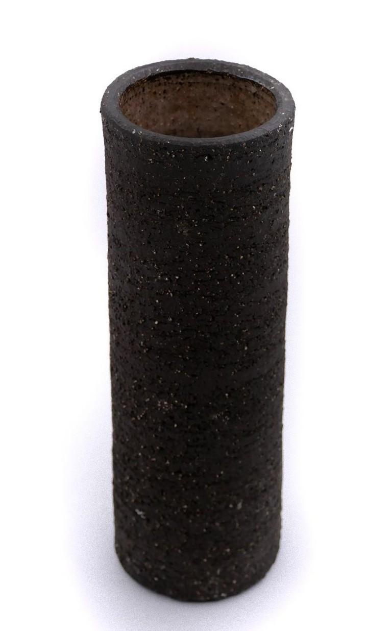 Vintage Chamotte vase is a rare decorative object realized in the 1970s by German manufacture. 

Realized entirely chamotte clay, a particular raw material for making ceramics with silica and alumina. Black-colored and with a cylindrical