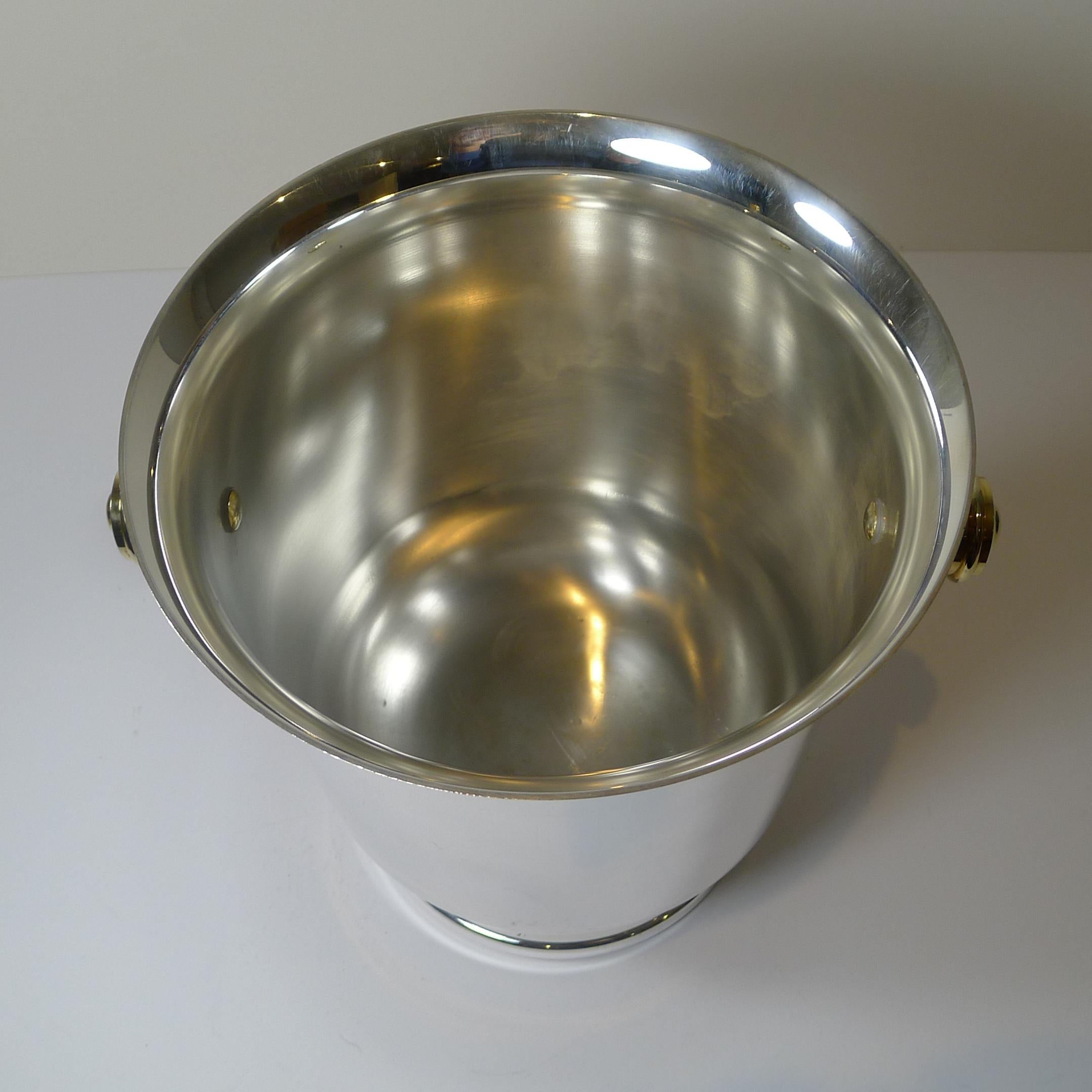 A fabulous and very on-trend French Champagne bucket, silver plate with modernist gold plated handles dating to the 1980's.

Just back from our silversmith's workshop where it has been professionally cleaned and polished, restoring it to it's