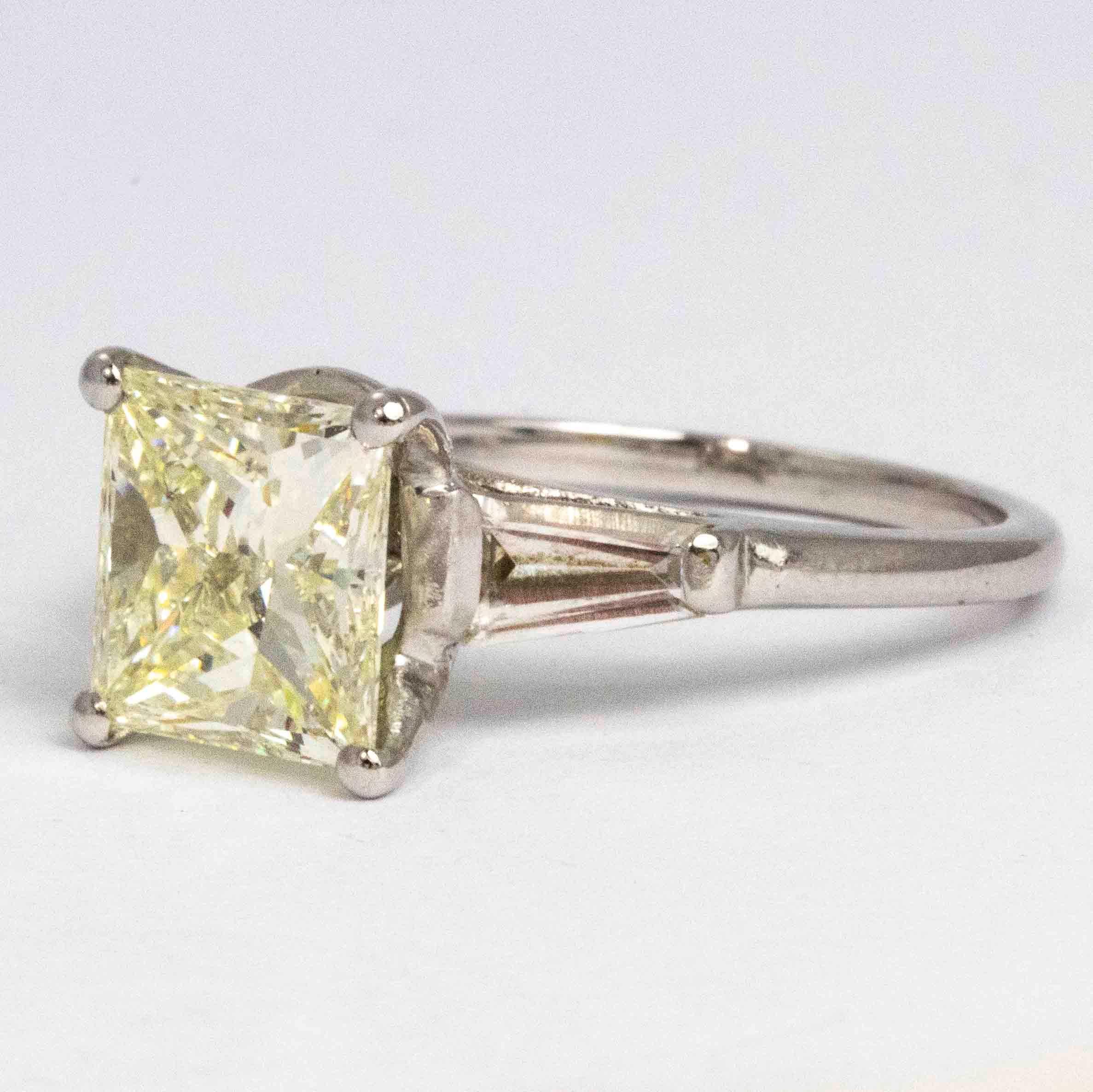 The champagne diamond in this ring is simply stunning. The princess cut stone is sat in-between two tapered baguette diamonds which have a wonderful shimmer. The centre stone is 2.76ct, measures 8mm x 8mm and glistens beautifully. 

Ring Size: L 1/2