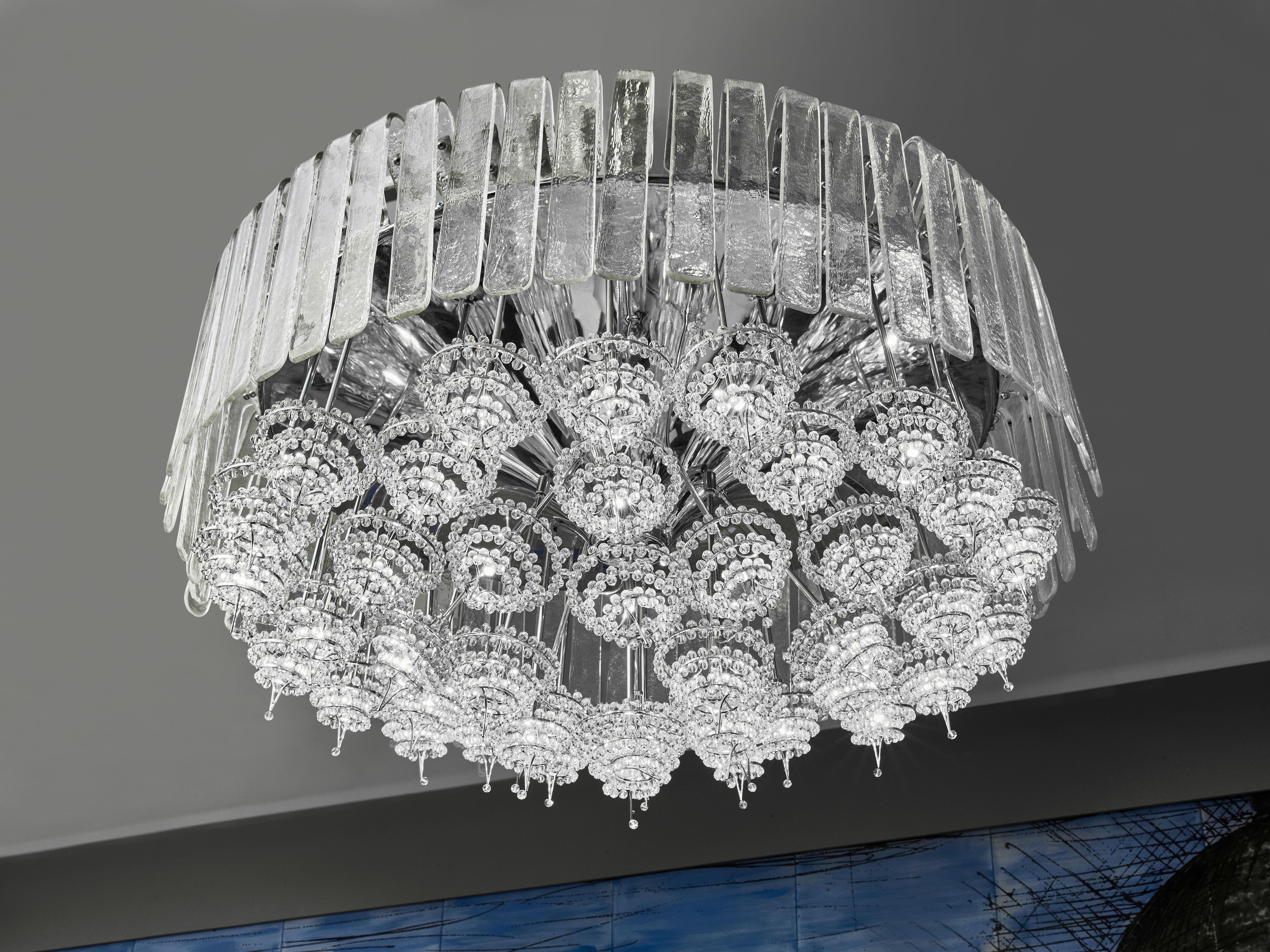 Exceptional chandelier in chromed steel, adorned with Murano glass plates and pearls.
Italy, 1980s.