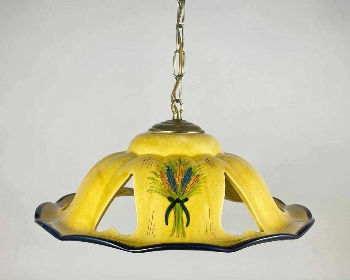 Unusual ceramic yellow chandelier from Spain, 1990s'.

Vintage ceiling light with flower bouquets decor on yellow background.
Pendant lamp with hand-painted ceramic lampshade on which hearts are carved. The base is made of metal painted in gold