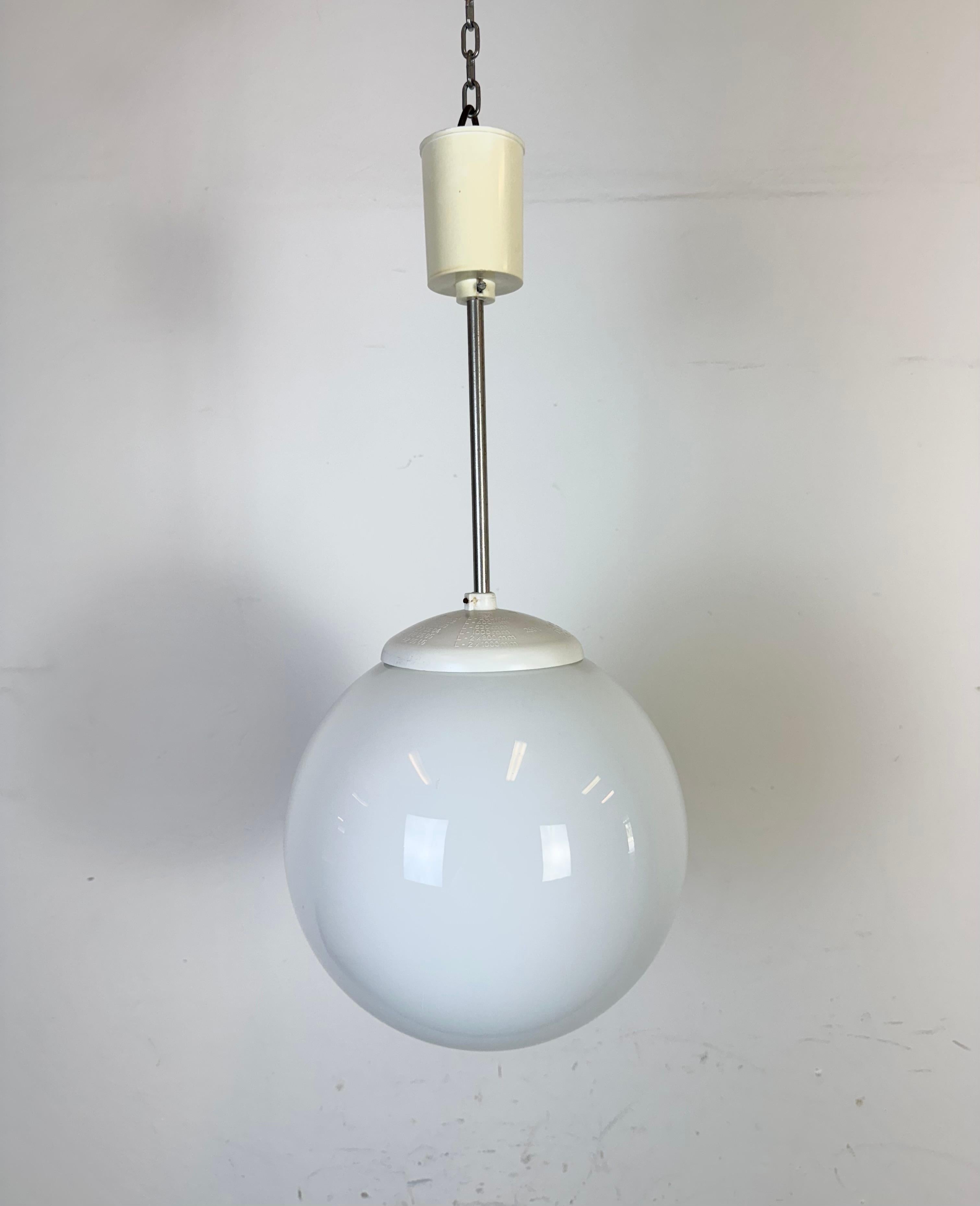 Vintage chandelier made by Elektrosvit in former Czechoslovakia during the 1960s. Made of milk glass ,chrome and bakelite. The porcelain socket requires standard E27 / E27 lightbubs. New wire. The diameter of the glass is 24 cm. Height : 50 cm.
