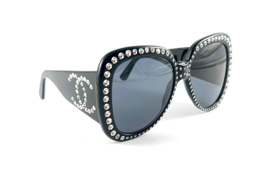 
From the Spring / Summer of 1994 Chanel Black 05257 94305 ultra black with strass accents frame.

New never Worn. This piece may show minor sign of wear due to storage.

This pair of Chanel sunglasses is an absolute showstopper.


Made in