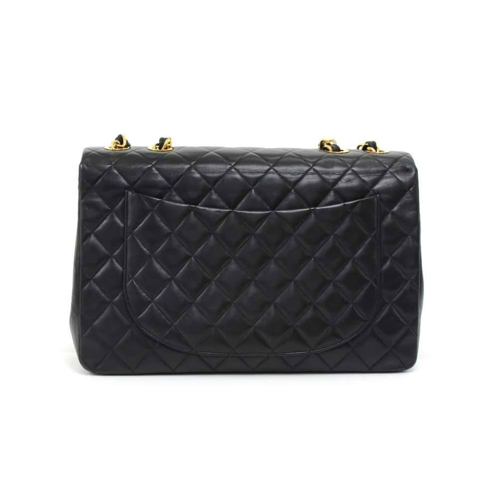 Vintage Chanel Maxi Jumbo in black quilted leather. It has flap top with famous large CC twist lock on the front. Outside on the back has 1 open side pocket. Inside has Chanel red leather lining and 2 pockets: 1 zipper and one open. Comfortably