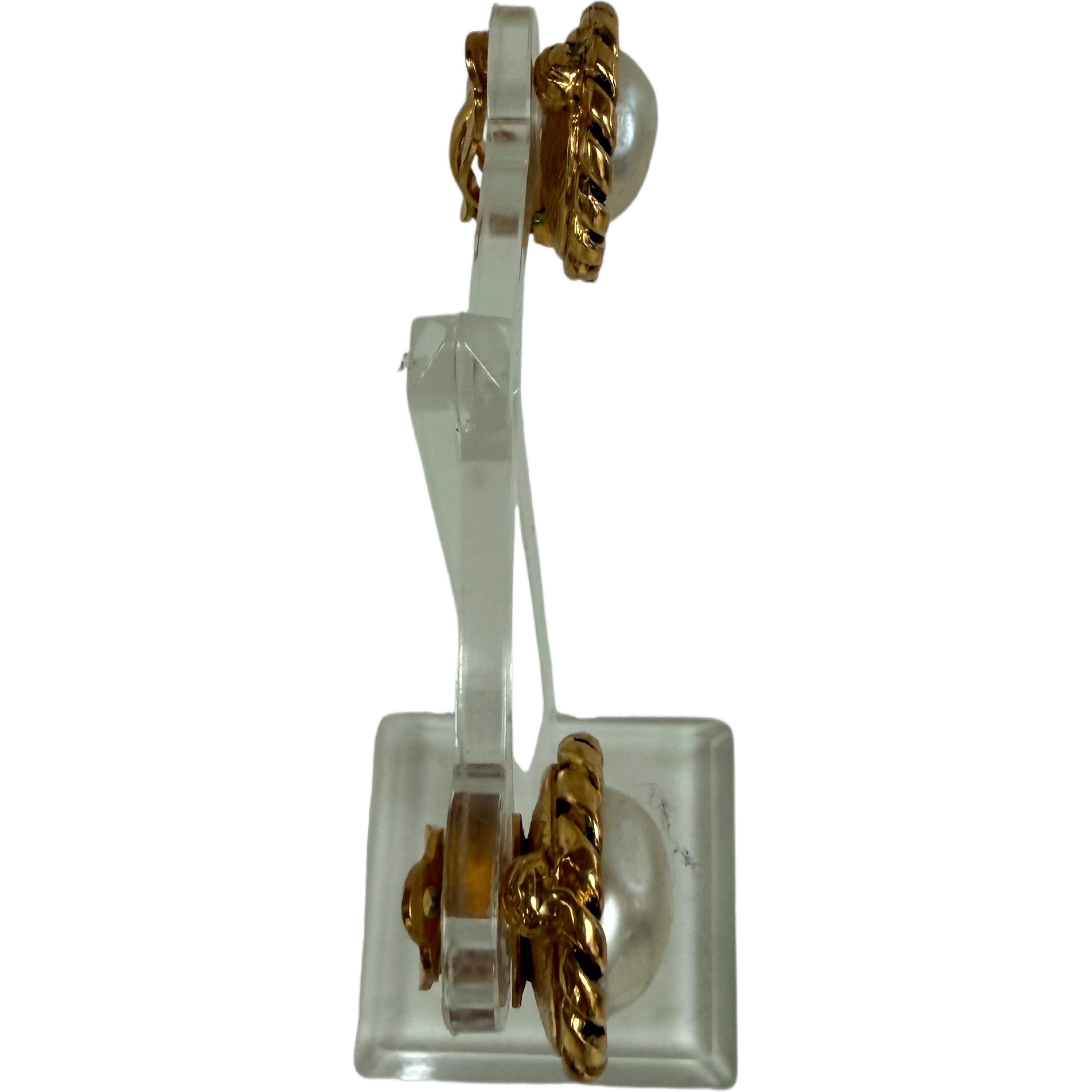 Rare, very collectible vintage Chanel pearl and gold logo clip-on earrings. Stamped Chanel, and from the 1983 collection. Can easily be dressed up or down, day to evening. All of the vintage clothing in the video are also in my 1stdibs Shop.
In good