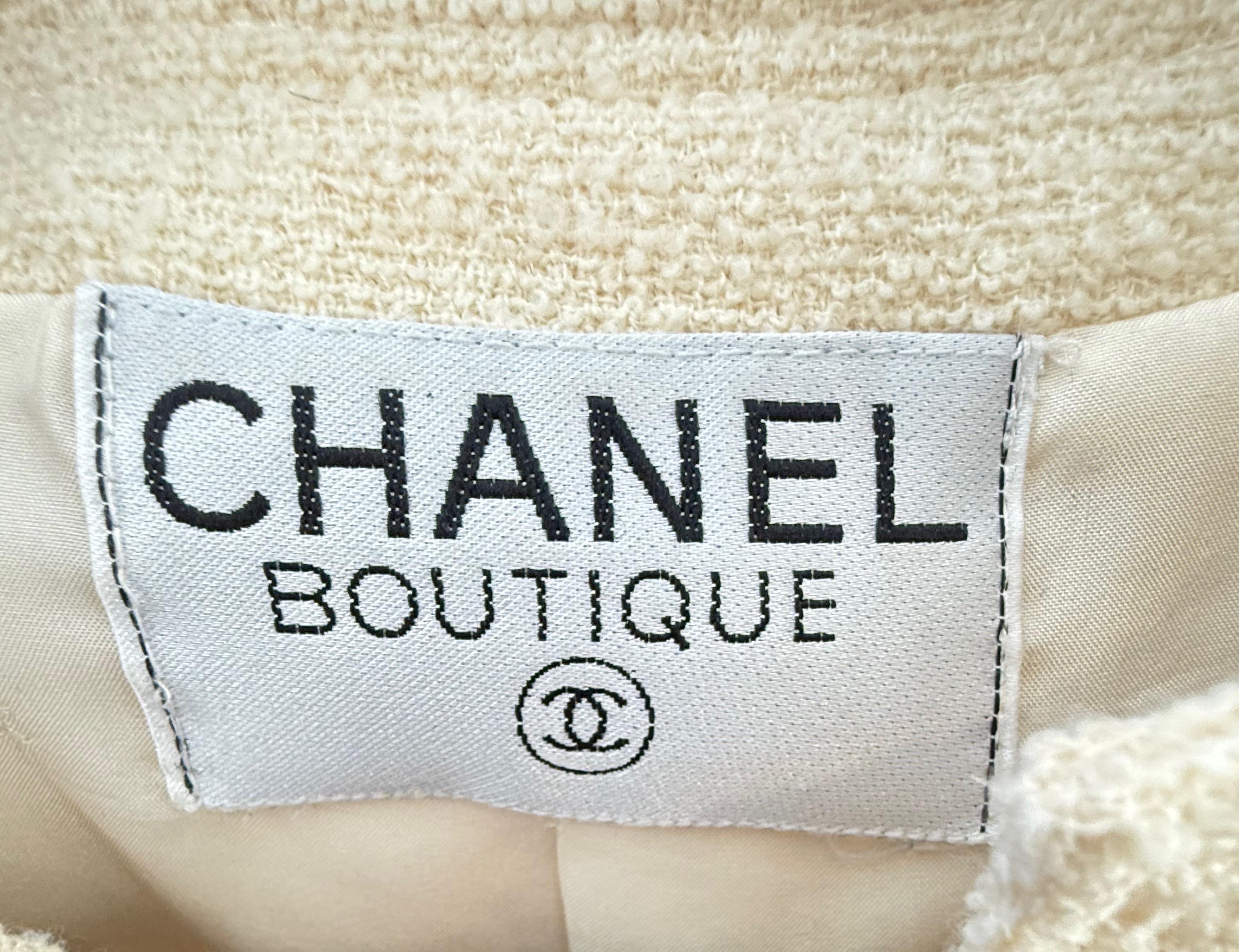 Chic and timeless late 90s Chanel, by Karl Lagerfeld ivory Boucle jacket blazer ! Features gold and enamel CC logo buttons  at each of the four pockets. Fully lined in silk, with signature chain at the inner hem. Pair with a blouse and skirt, over a