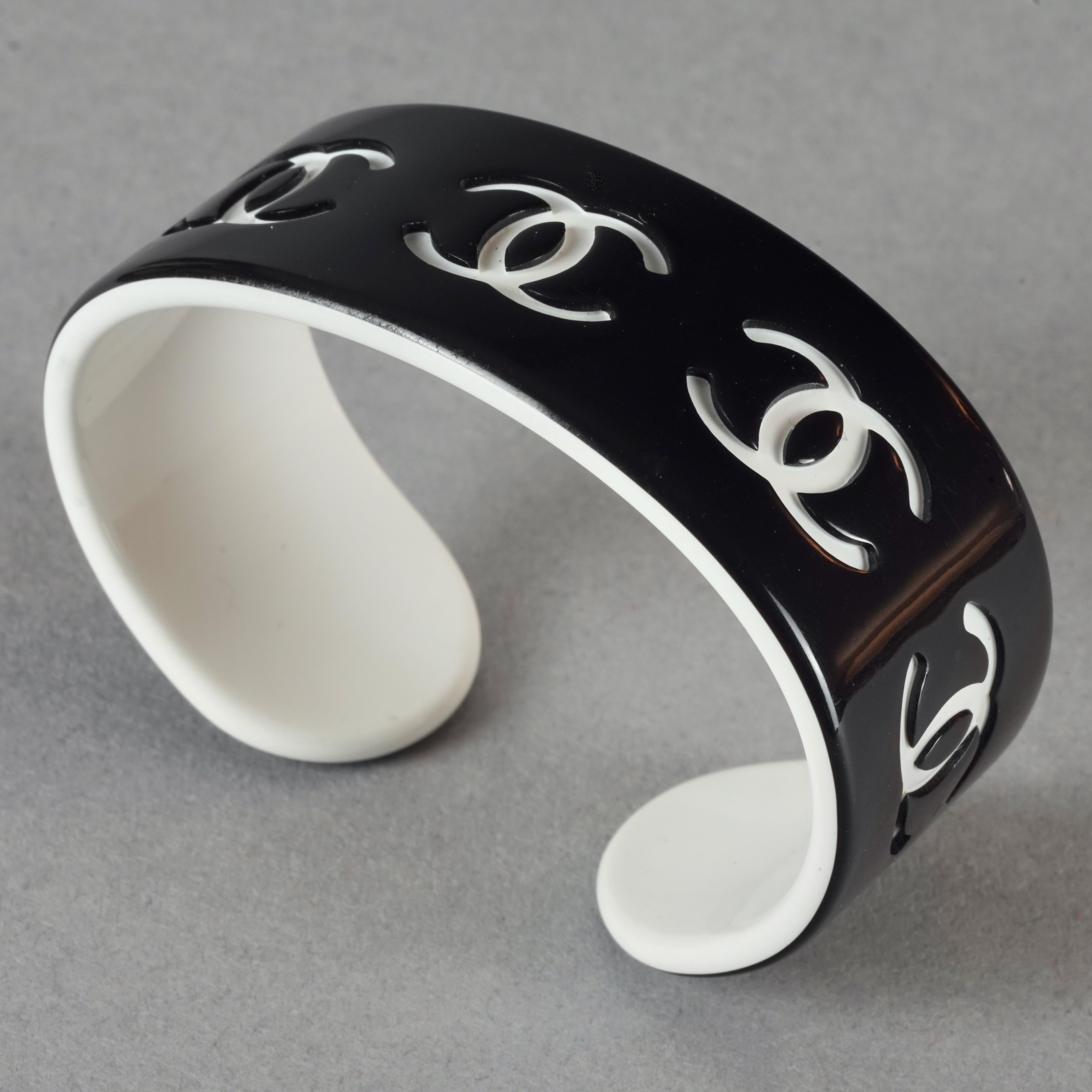 Vintage CHANEL 2002 Black and White CC Logo Perspex Cuff Bracelet

Measurements:
Height: 0.86 inch (2.2 cm)
Maximum Circumference: 6.18 inches (15.7 cm) including the opening

Features:
- 100% Authentic CHANEL.
- Black perspex cuff bracelet with