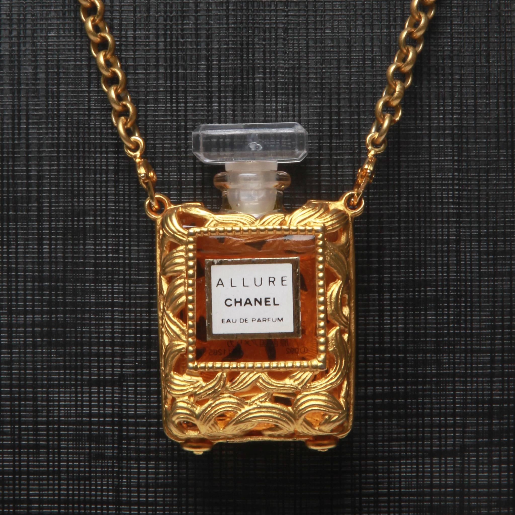 Coveted Chanel gold necklace featuring a miniature real Chanel 'Allure' perfume bottle in an ornate gold-tone holder as pendant. 31