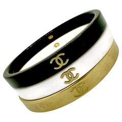 Juego de 3 brazaletes Chanel vintage: en negro, blanco y dorado con logotipo CC