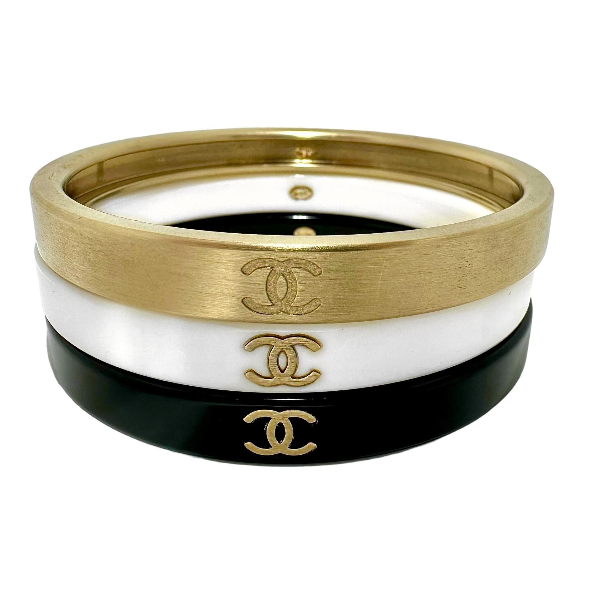 This wonderful, vintage Chanel set was released as part of the Autumn 2010 collection. Fabricated from Gold Tone brushed metal and resin. Each of the three bracelets is embossed with the CHANEL double C logo in three places. Inside each piece is a