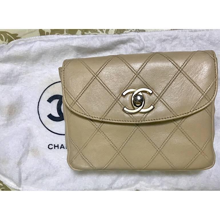 1990s. Vintage CHANEL beige leather waist purse, fanny pack, hip bag with gold CC closure and chain belt. Good for waist size 26.5” through 30.1