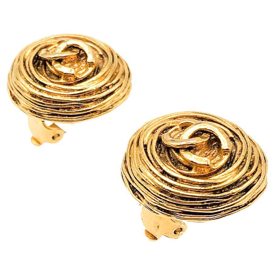 These quintessential Vintage Chanel Birds Nest Earrings topped with the iconic interlocking CC logo were created during the heyday of the supermodel, in 1994. The nest-like surround indicating these were most likely by the legendary Parisian