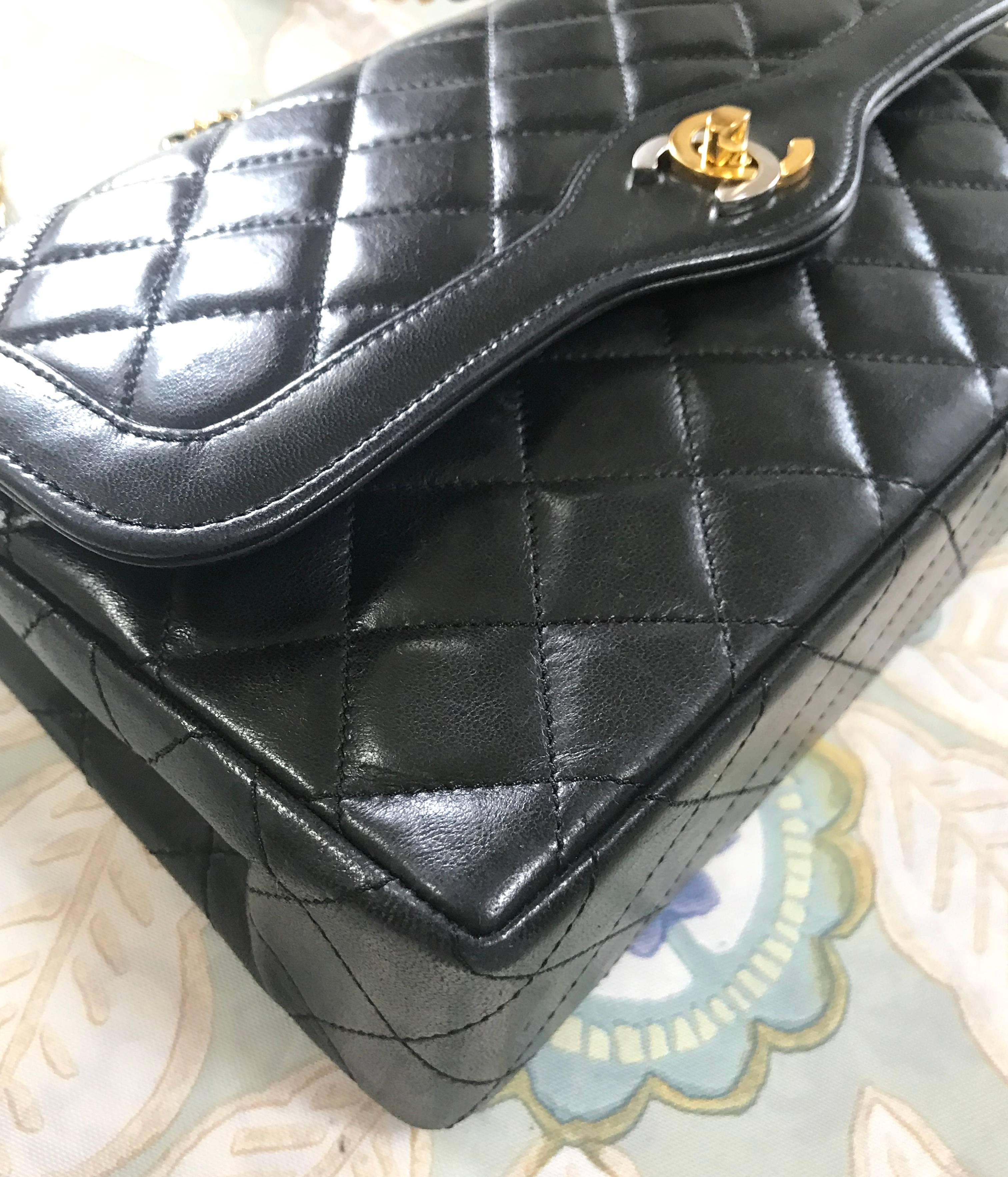 Vintage Chanel black 2.55 classic double flap bag with gold and silver CC motif. For Sale 3