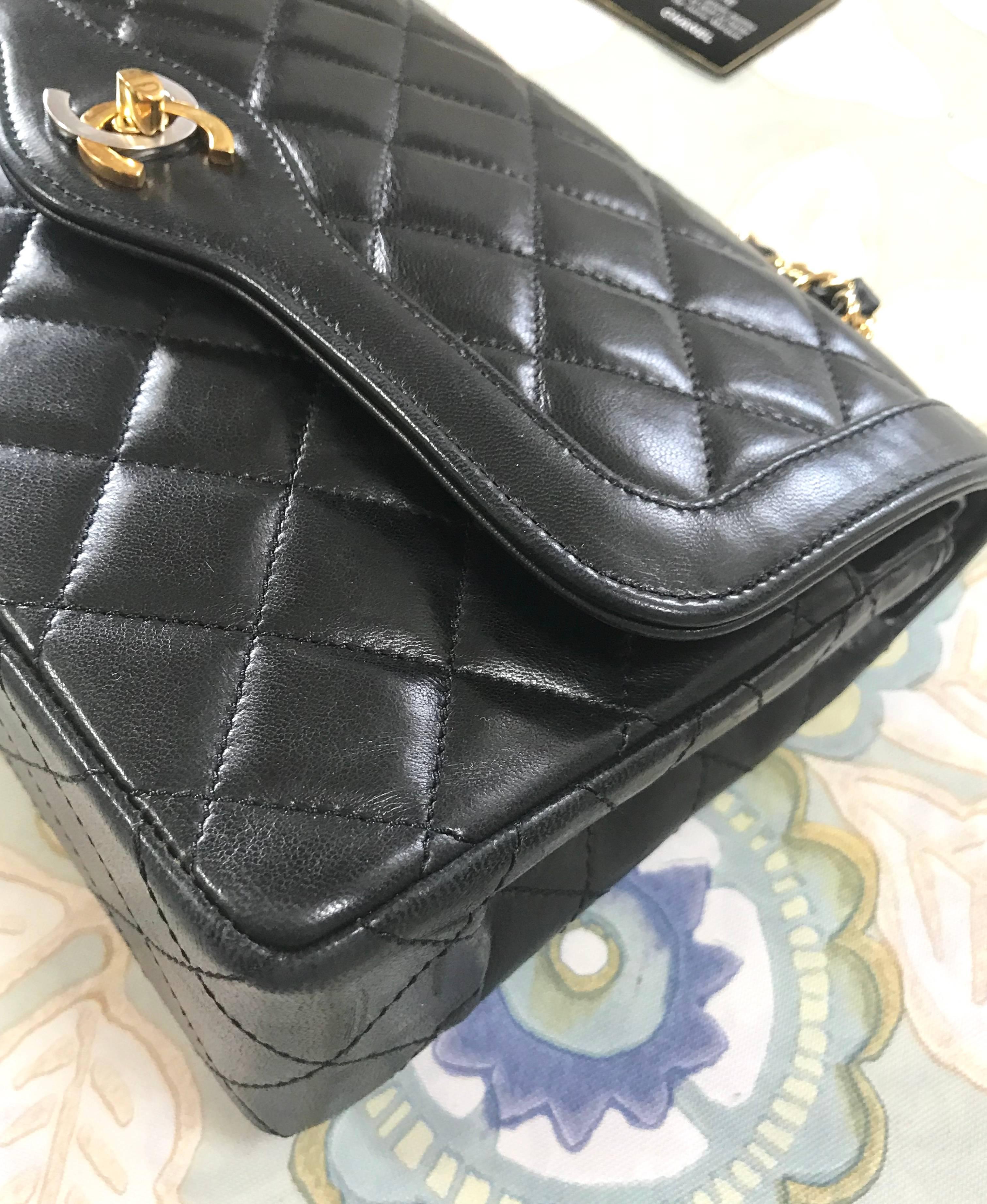 Vintage Chanel black 2.55 classic double flap bag with gold and silver CC motif. For Sale 4