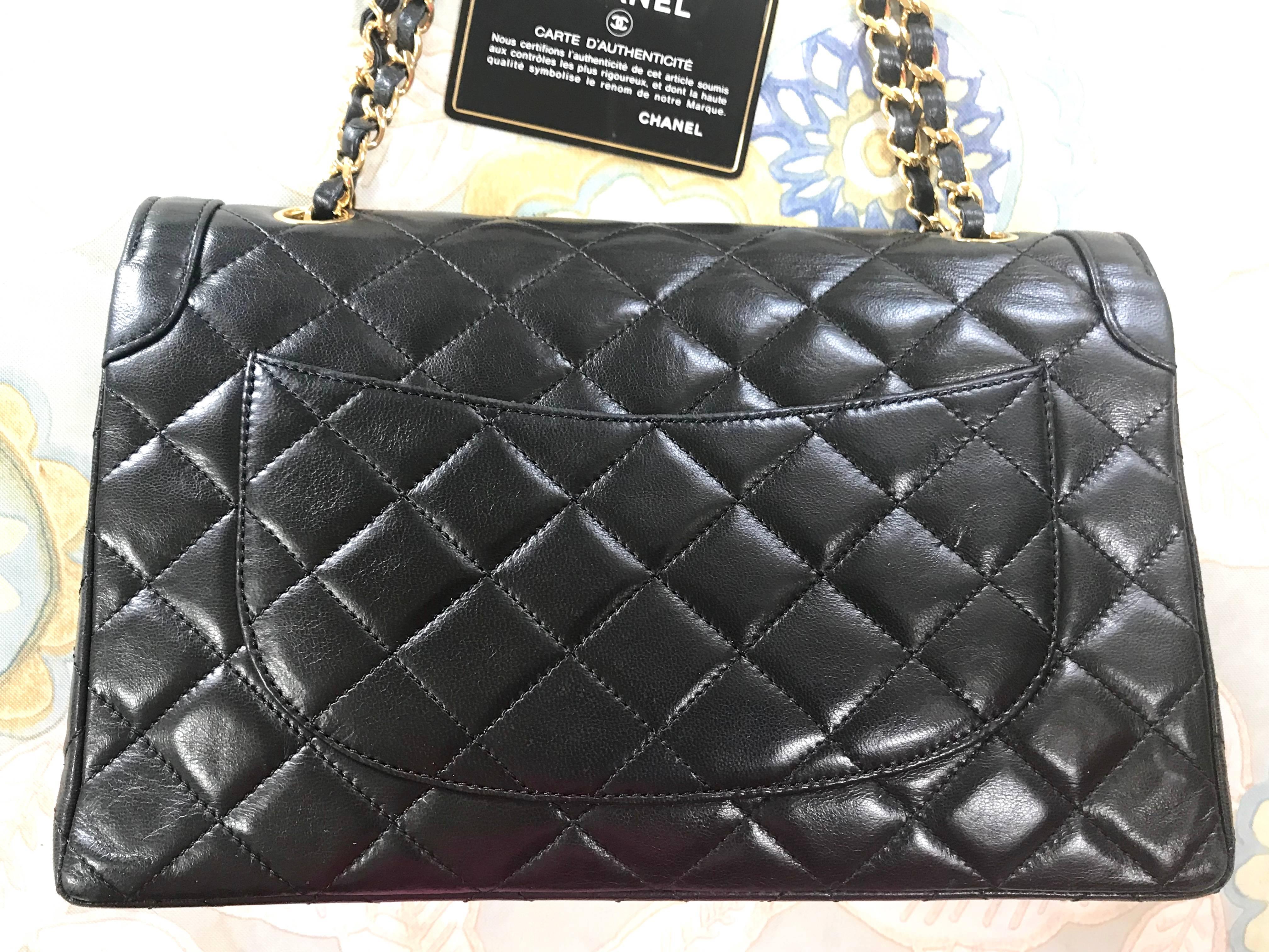 Black Vintage Chanel black 2.55 classic double flap bag with gold and silver CC motif. For Sale