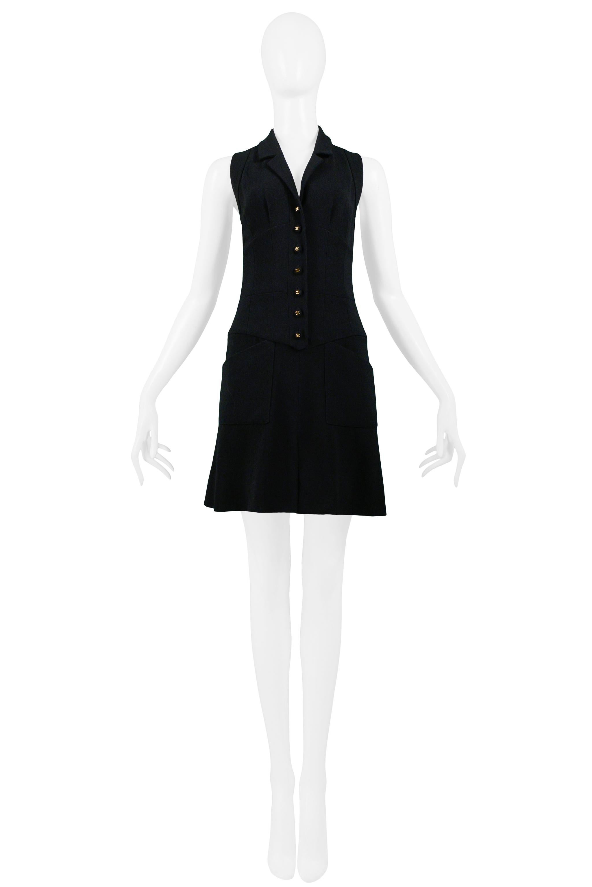 Vintage Chanel black wool button front sleeveless mini dress with Chanel logo buttons, fitted seamed waist, and angled pockets at hips. Collection 1995.

Excellent Vintage Condition.

Size 38