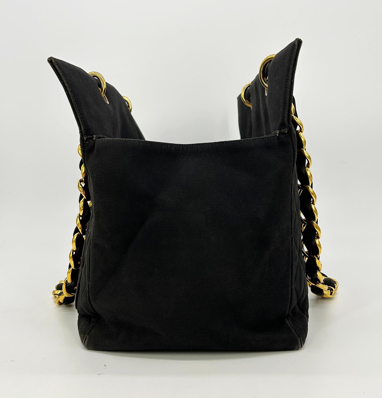 Vintage Chanel Black Canvas Grand Shopper Tote in fair condition. Black quilted canvas exterior trimmed with gold hardware. Signature diamond quilted pattern canvas along front and back with CC logo centered on front. Smooth canvas sides and bottom.