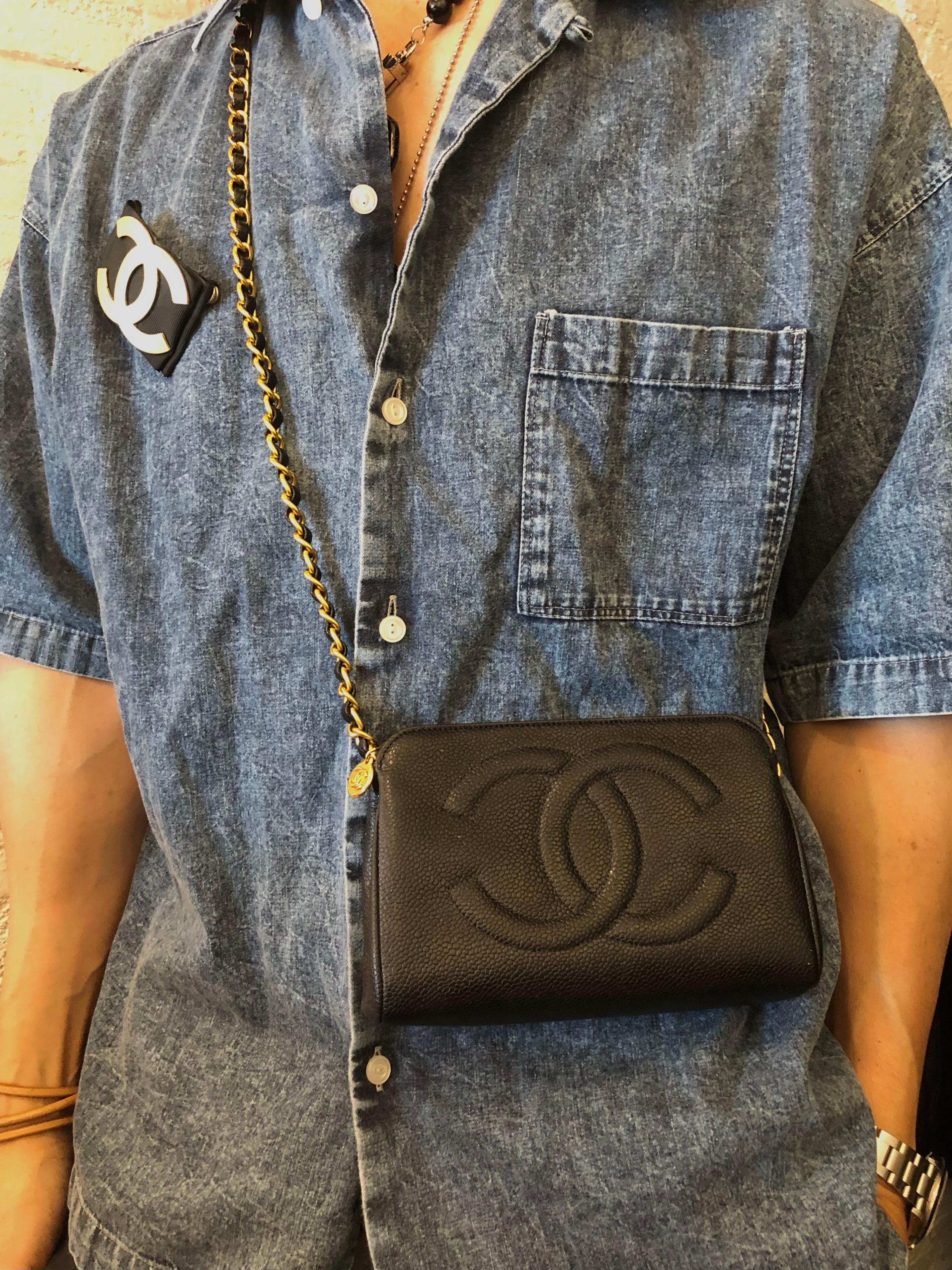 This 1990s CHANEL pouch bag is crafted of caviar leather in black. Top zipper closure opens to a newly re-lined interior in beige. Holo 5xxxxxx series made in Italy (stamps removed in the re-lining process) Measures approximately 7 x 4 x 2 inches.