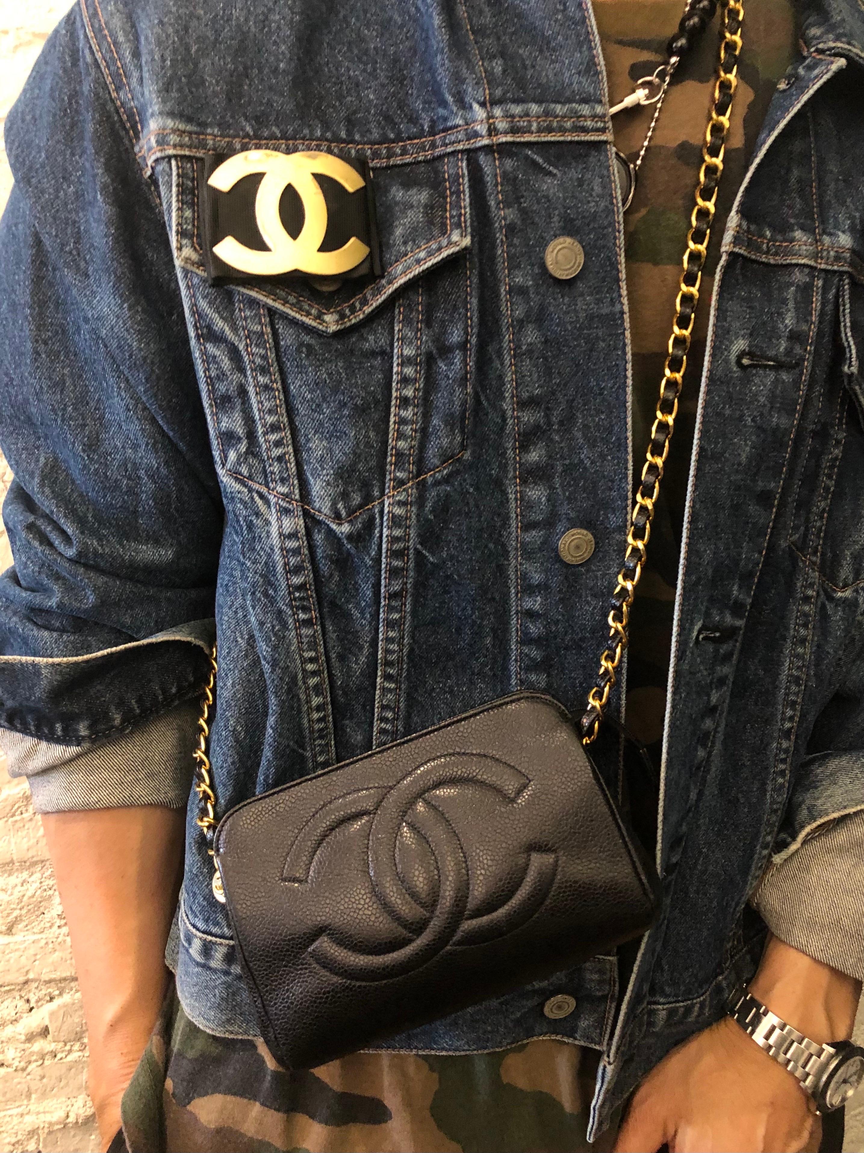 This vintage CHANEL pouch bag is crafted of caviar leather in black. Top zipper closure opens to a luxurious beige lambskin leather interior (re-lined by Chanel Japan with repair seal but hologram stickier removed). Third party hardware are added on