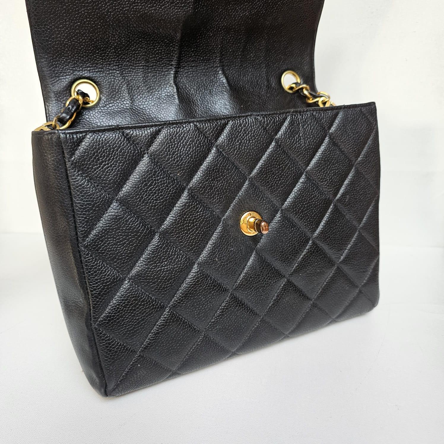 Rare vintage square flap bag in black caviar leather. Beautiful vintage condition. Series #4. Minor wrinkling on the leather flap. Comes with holo and dust bag only.