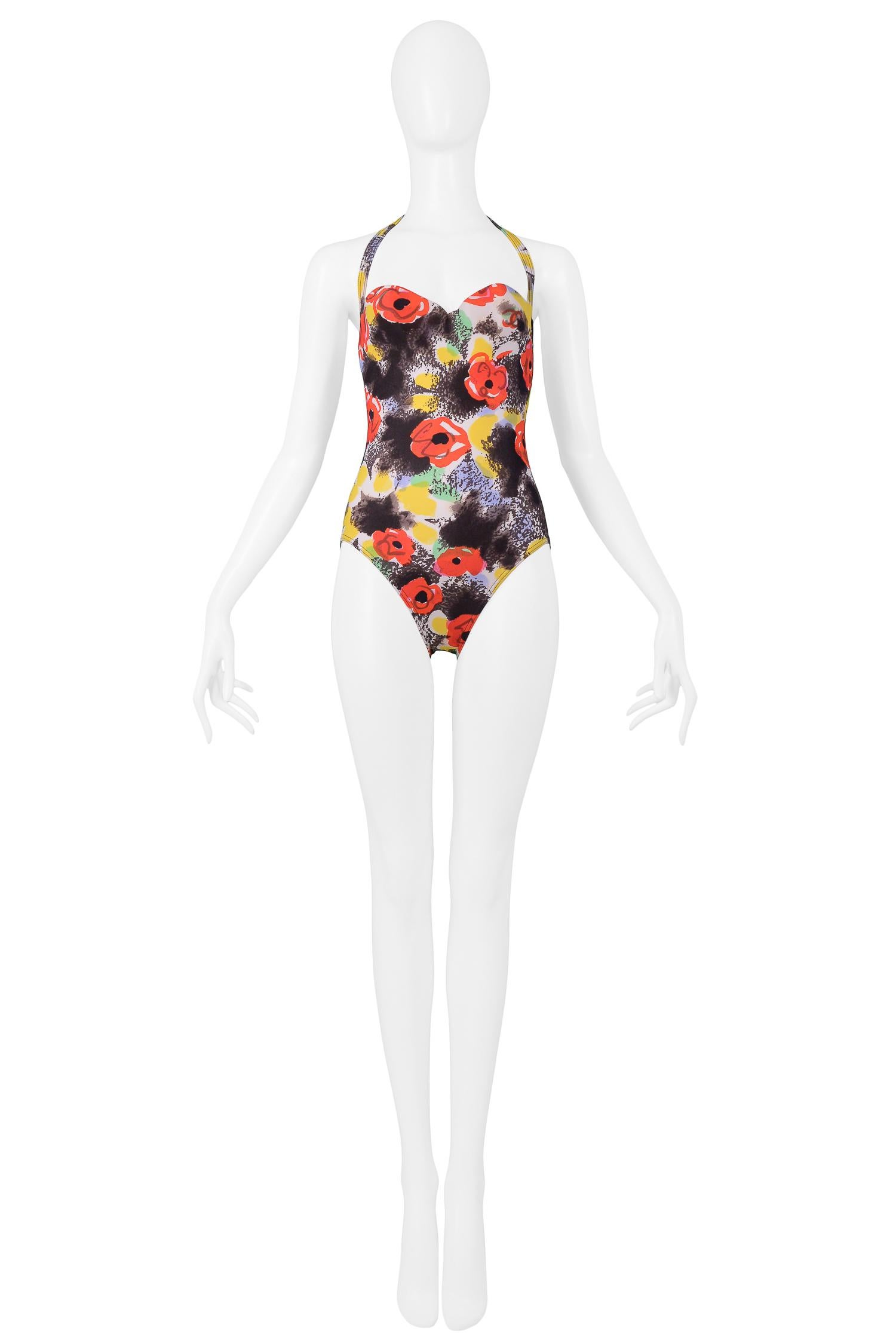 Vintage Chanel black, red, and yellow floral printed one piece swimsuit featuring tie back halter and sweetheart neckline.

Excellent Vintage Condition.

Size 38